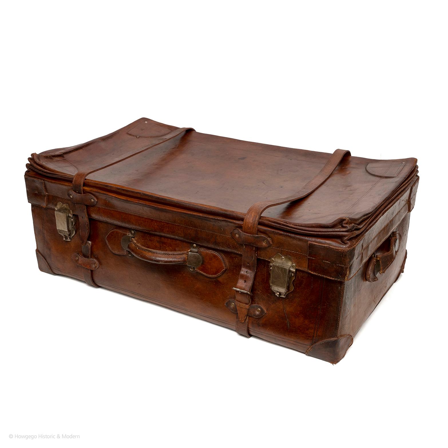 A fine large 19th century, thick, high quality leather overseas travelling trunk with reinforced exposed straps, handles and chrome hardware stamped USA with internal locking mechanism and ring for padlocks.  No key.  Repair to one strap and one