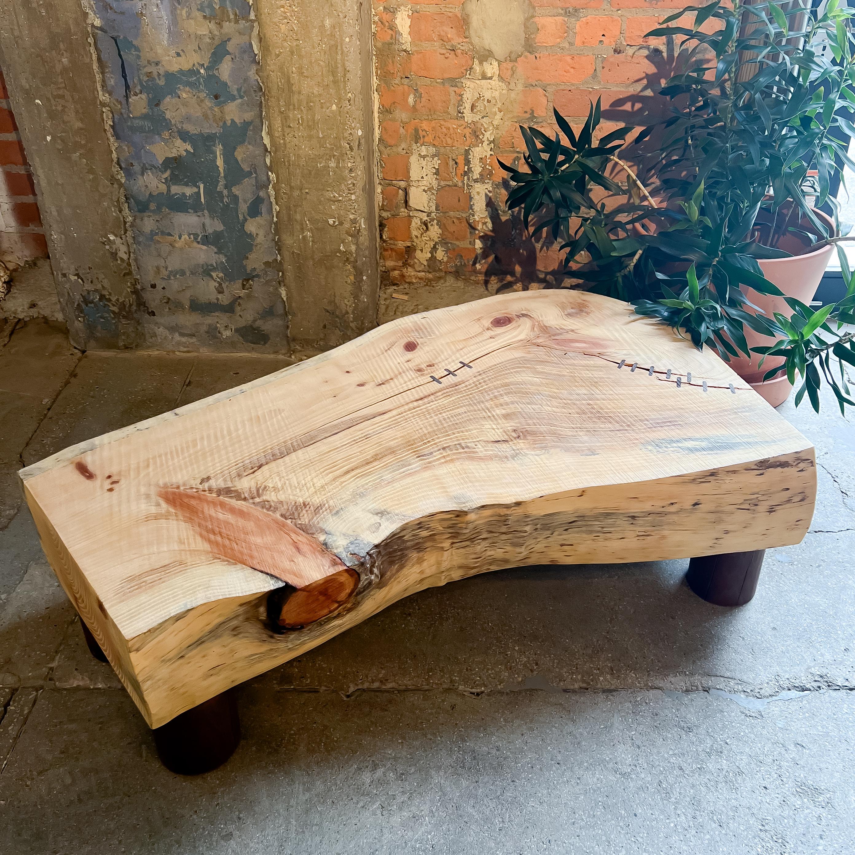 Intricate wooden table in unique organic form with five legs.  The table top is made from White Pine with natural accenting throughout due to the saw-milling processes.  Walnut is used for the short cylindrical legs that also have prominent natural