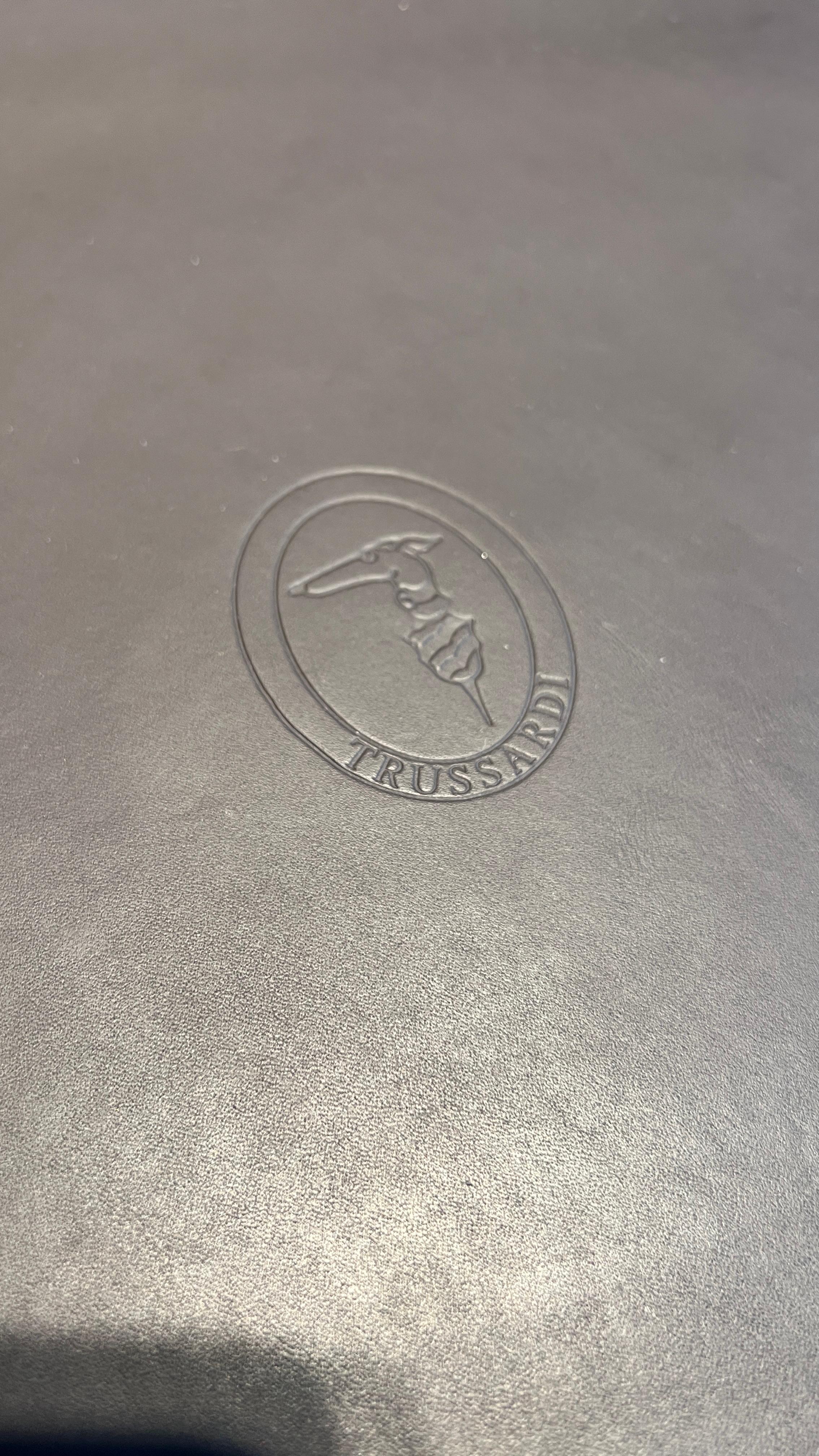 The beautiful Trussardi Sidetable is a luxurious piece that combines elegance, craftsmanship, and modern aesthetics. Featuring a leather surface with logo embossing, it showcases the brands attention to detail and sophistication. The bronze-finished