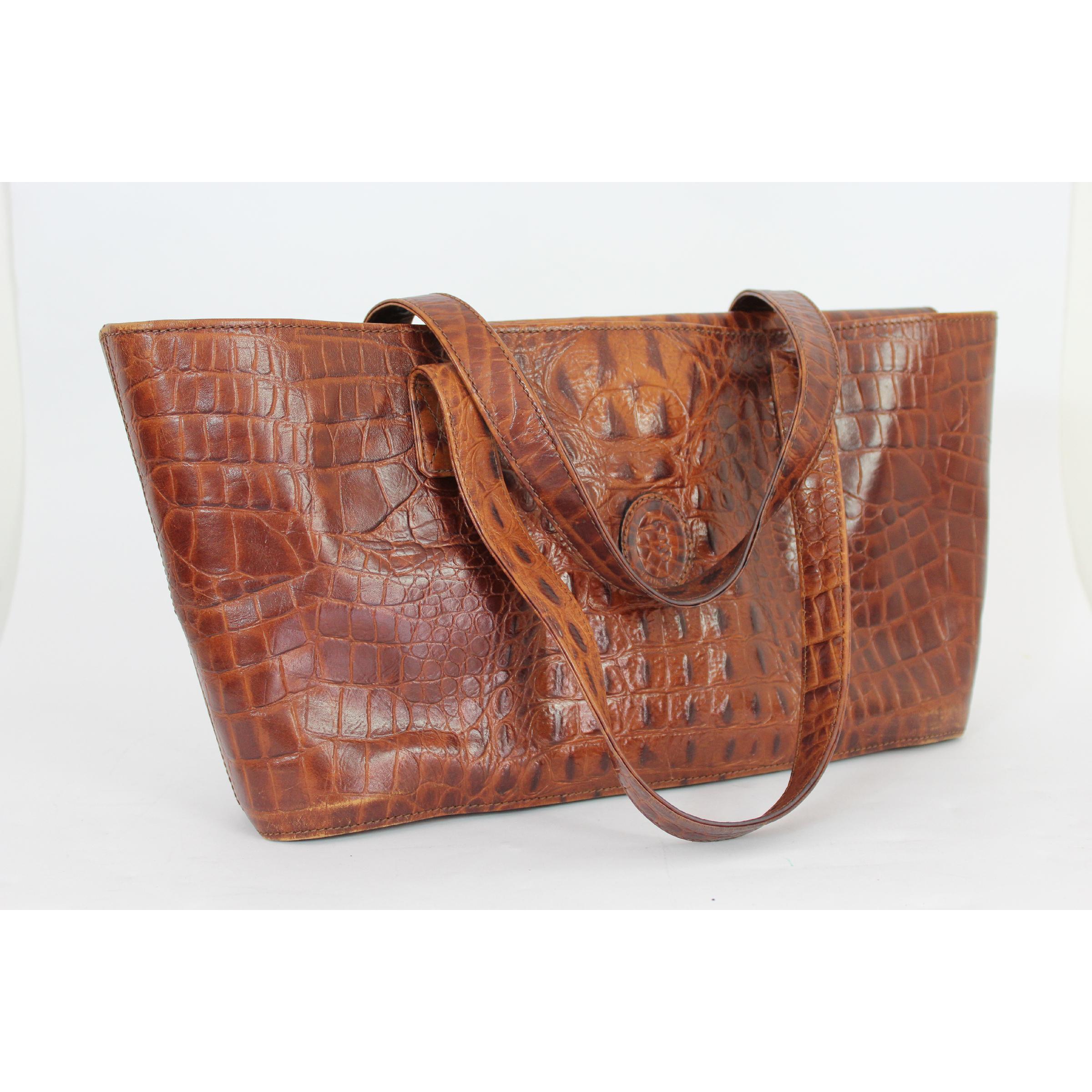 Trussardi vintage 80s handbag. Rigid shopper model, 100% crocodile print leather, brown color, clip closure. Made in Italy. Excellent vintage condition. 

Height: 22 cm 
Width: 46 cm 
Depth: 10 cm