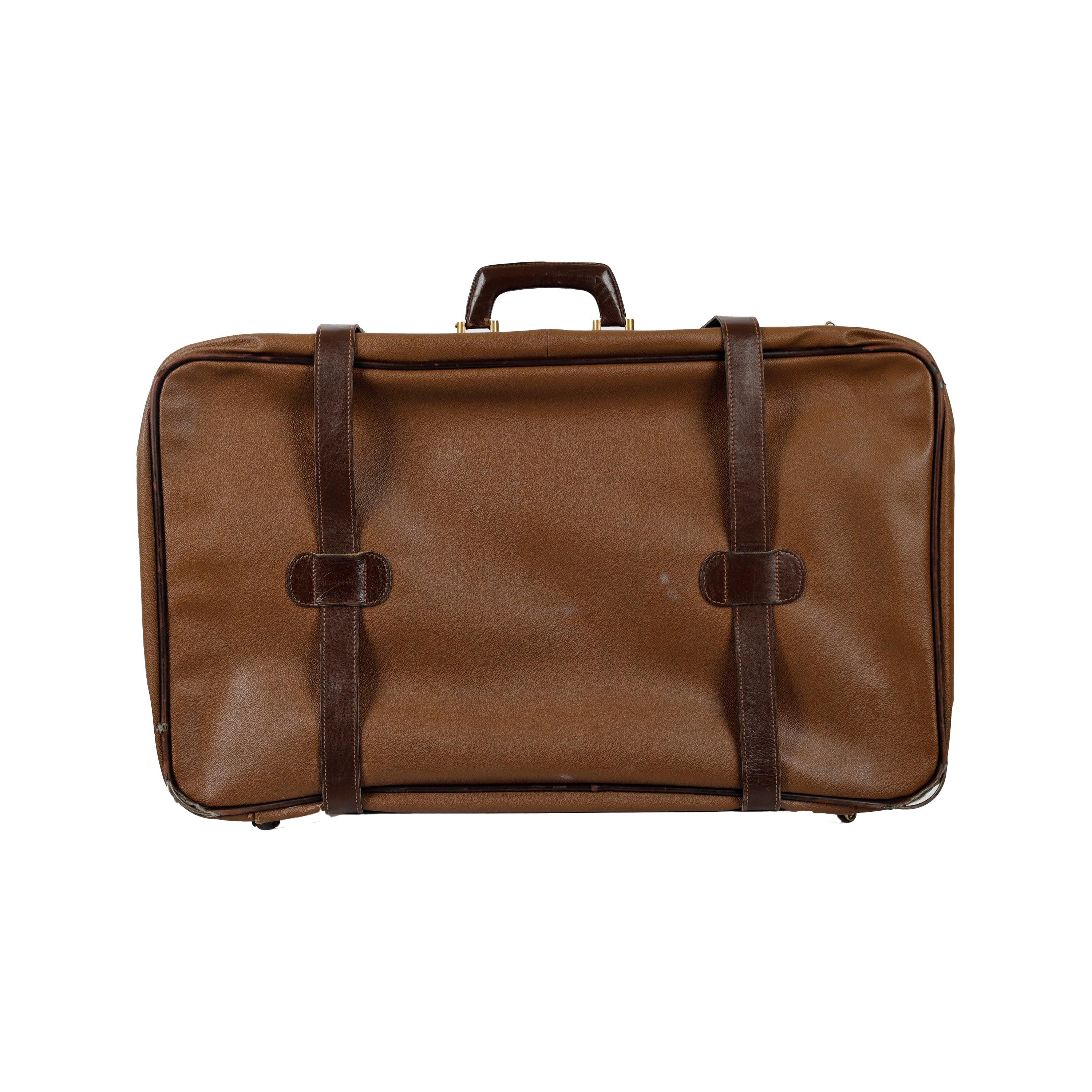 Crafted from light brown leather with contrast straps and gold tone hardware for a luxe, vintage look, the Trussardi Vintage Leather Luggage features four small wheels for convenience and ease of travel. The inside linings are printed with the brand