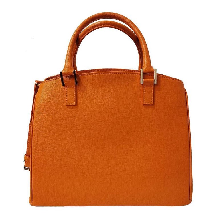 Leather Orange color Two handles Can be worn crossbody too External pocket Double internal compartment, divided by zip pocket 3 Additional pockets, one zipped Cm 31 x 26 x 14 (12,2 x 10,2 x 5,5 inches)