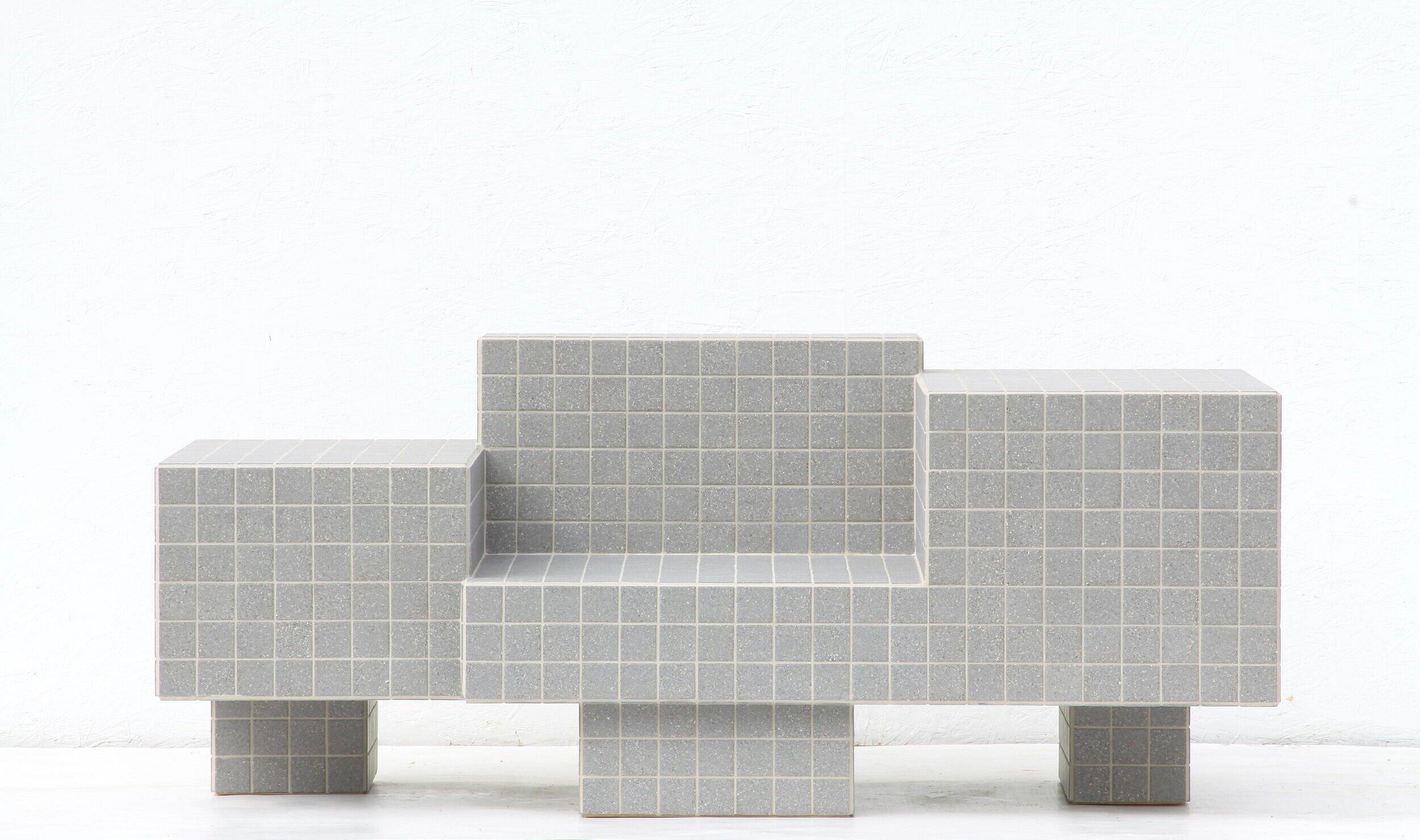 Designed and made by Nima Abili in Los Angeles this handcrafted table is cladded with speckled grey matte porcelain tiles and sanded grey grout. Inspired by Brutalist style of architecture this collection offers a variety of pieces designed based on