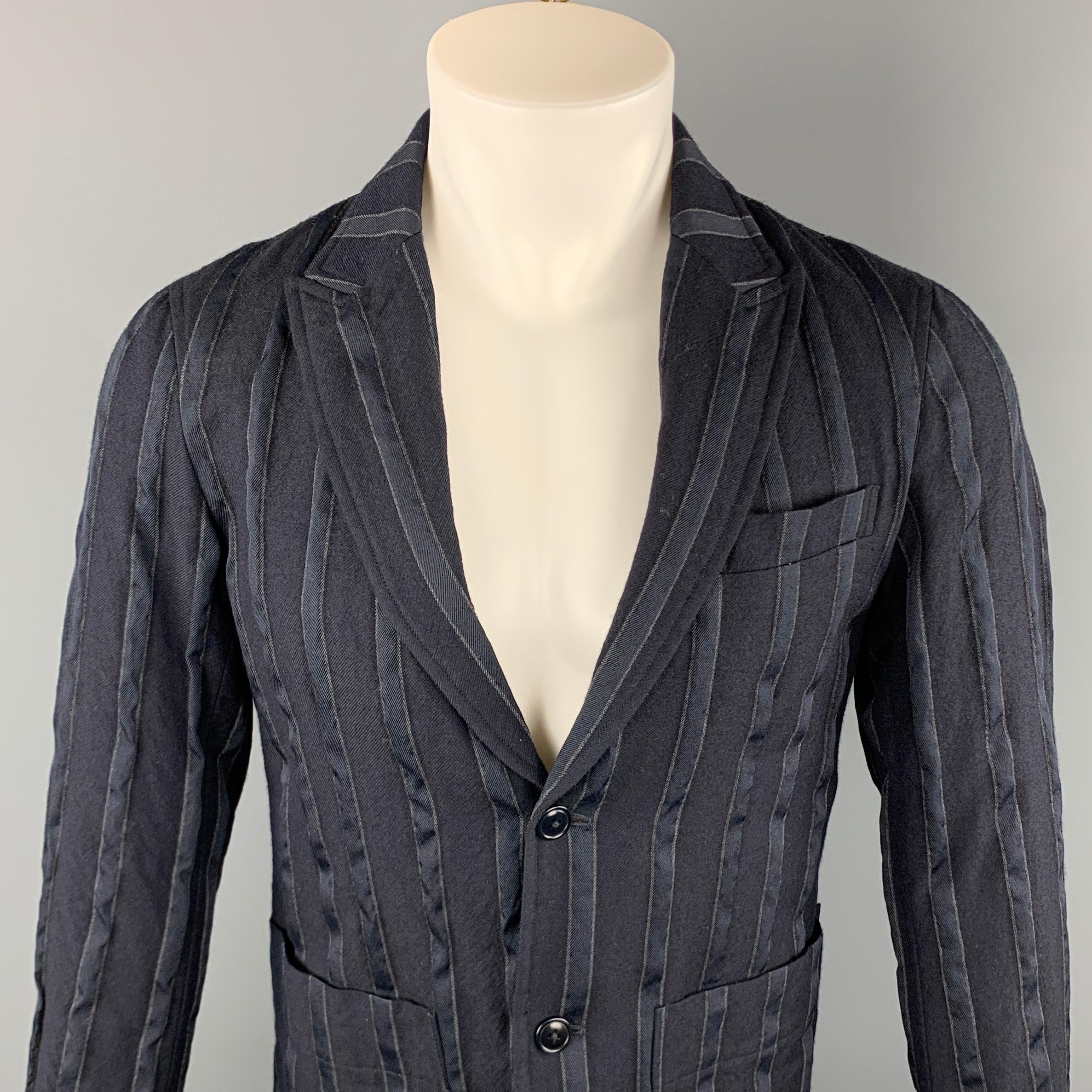 TS (S) sport coat comes in a navy stripe wool / polyester featuring a peak lapel, patch pockets, and a two button closure. Made in Japan. 

Excellent Pre-Owned Condition.
Marked: 1

Measurements:

Shoulder: 16 in. 
Chest: 38 in. 
Sleeve: 24.5 in.