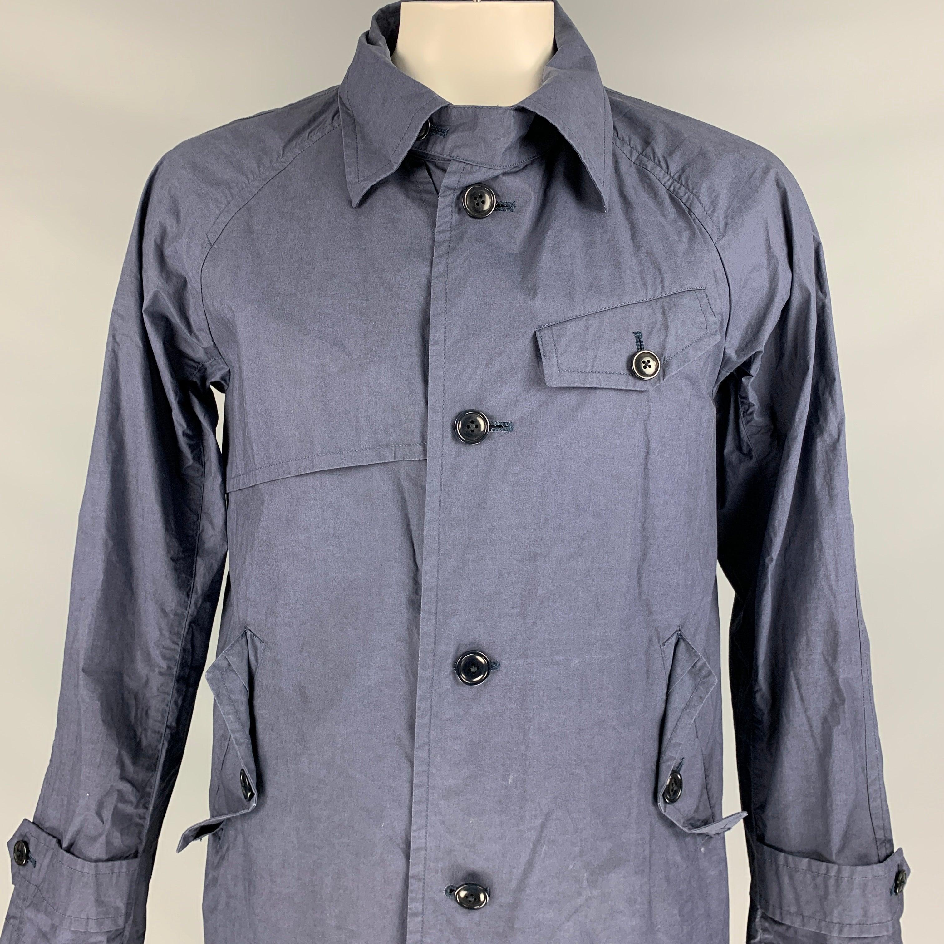 TS(S) jacket comes in a navy cotton featuring a spread collar, flap pockets, and a buttoned closure. Made in Japan.
Very Good
Pre-Owned Condition. 

Marked:   JP 4 

Measurements: 
 
Shoulder: 18 inches  Chest: 44 inches  Sleeve: 27 inches  Length: