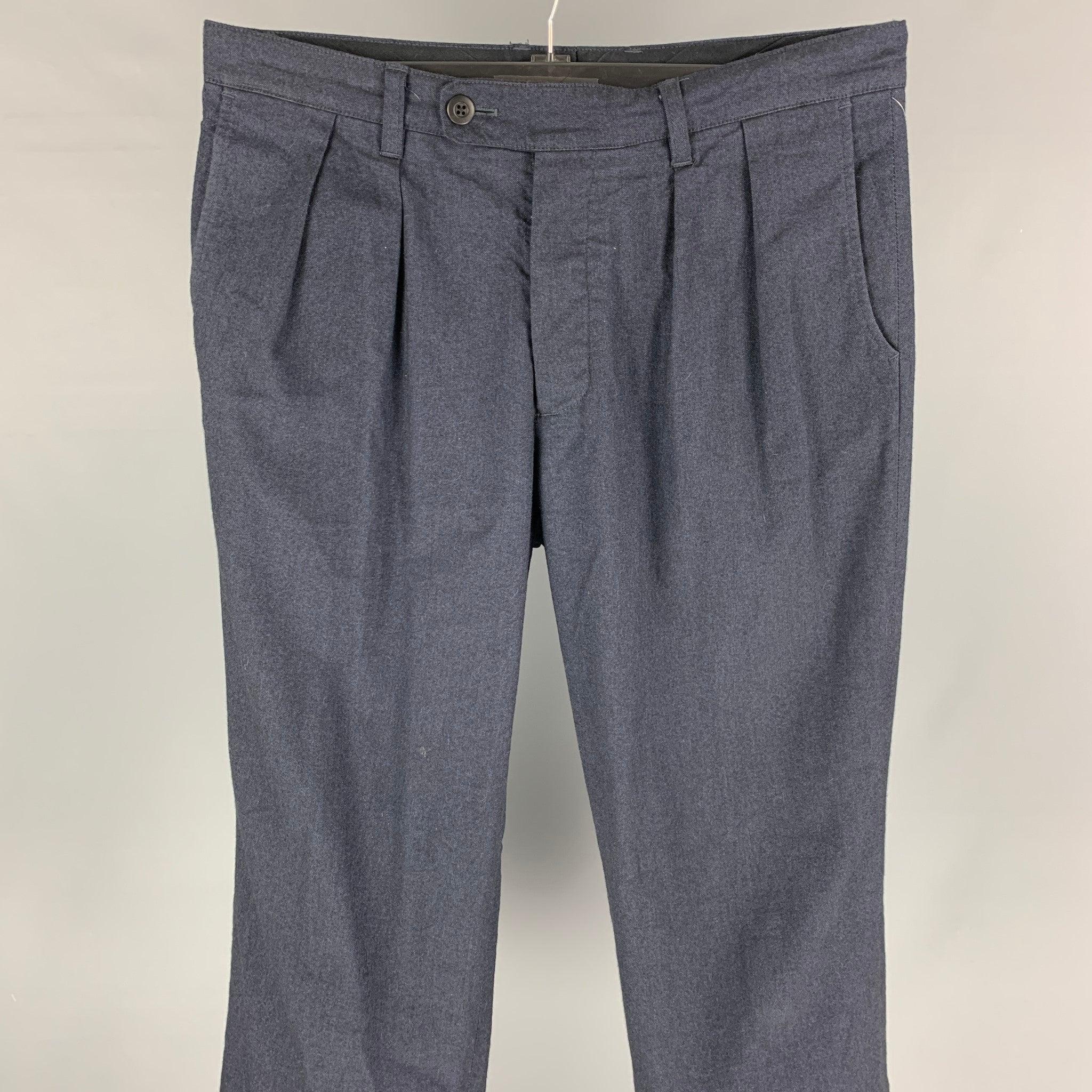 TS (S) dress pants comes in a indigo cotton blend featuring a pleated style, wide leg, cuffed, and a button fly closure. Made in Japan.
Very Good
Pre-Owned Condition. 

Marked:   2 

Measurements: 
  Waist: 34 inches  Rise: 12.5 inches  Inseam: 28