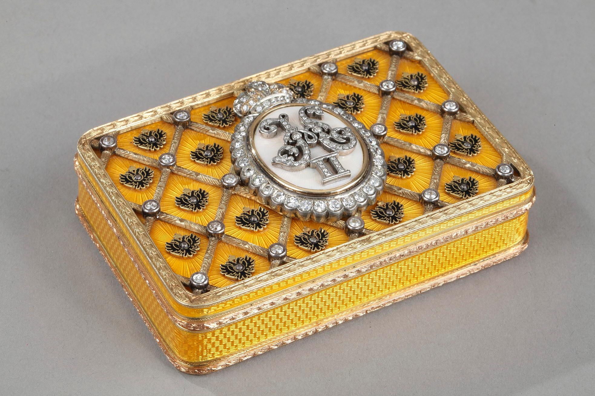 Important rectangular gold box in translucent yellow enamel on a radiant guilloche. The enamelled cover is decorated with a gold trellis which is embellished with diamonds and features imperial double-headed eagles. The lid presents a central