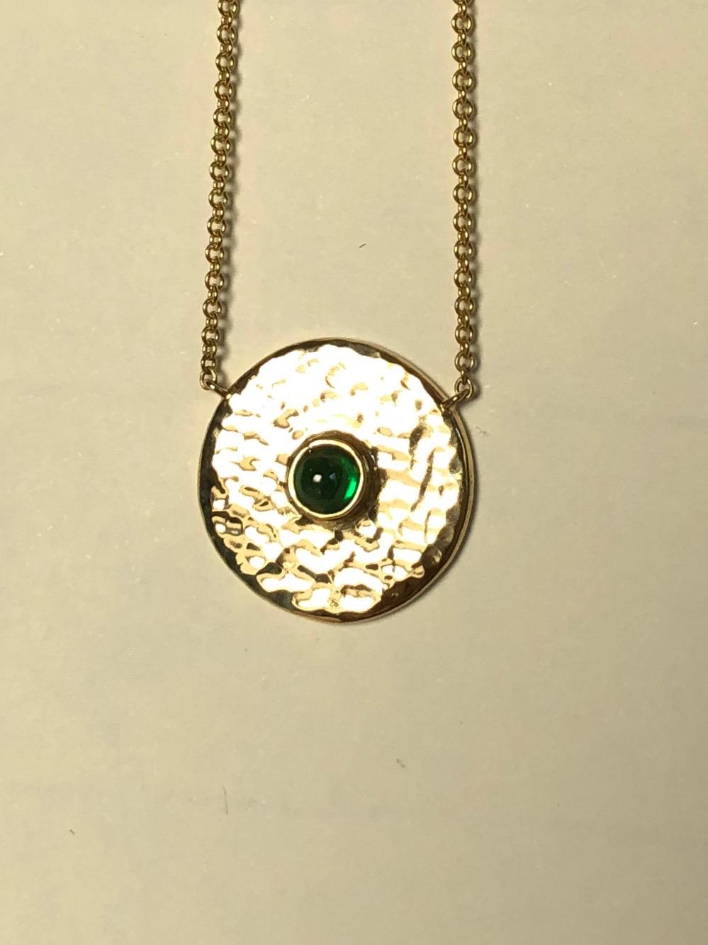 A Tsavorite cabochon is is nestled in a hand hammered disc of 18 karat gold. Centering, a pendant to wear every day and perhaps never take off. 



Tsavorite cabochon 3 mm from Bridges Tsavorite.
18 karat 100% recycled gold.
Made by Hand in