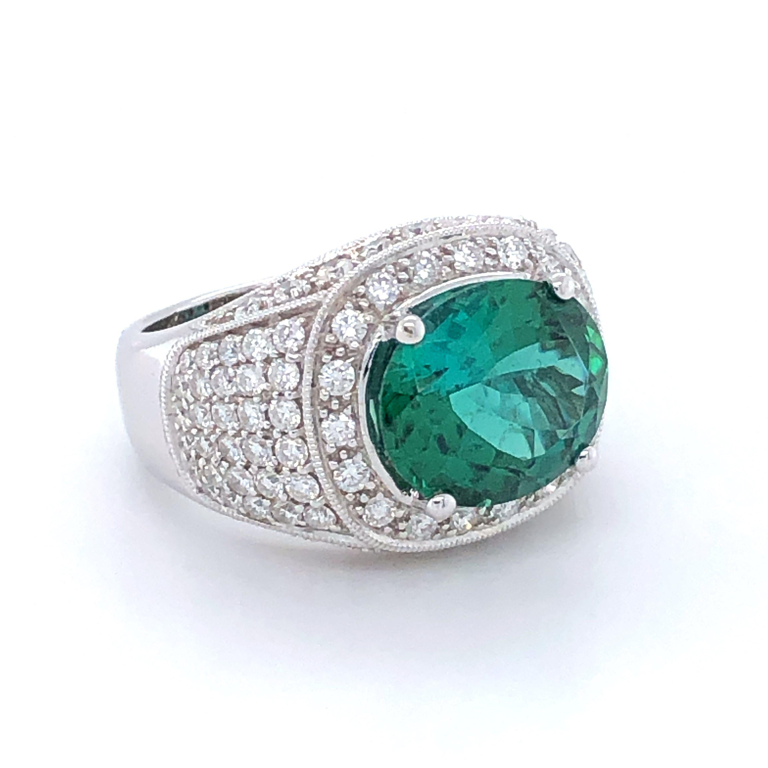 18k White Gold 5.0ct Tsavorite And .91ct Diamond Ring

Big Tsavorites are hard to find. Only way to do justice to this huge stone was to give it a boulderish look and surrounding it with halo of diamondsItem:
 # 03866
Metal: 18k White Gold
Color