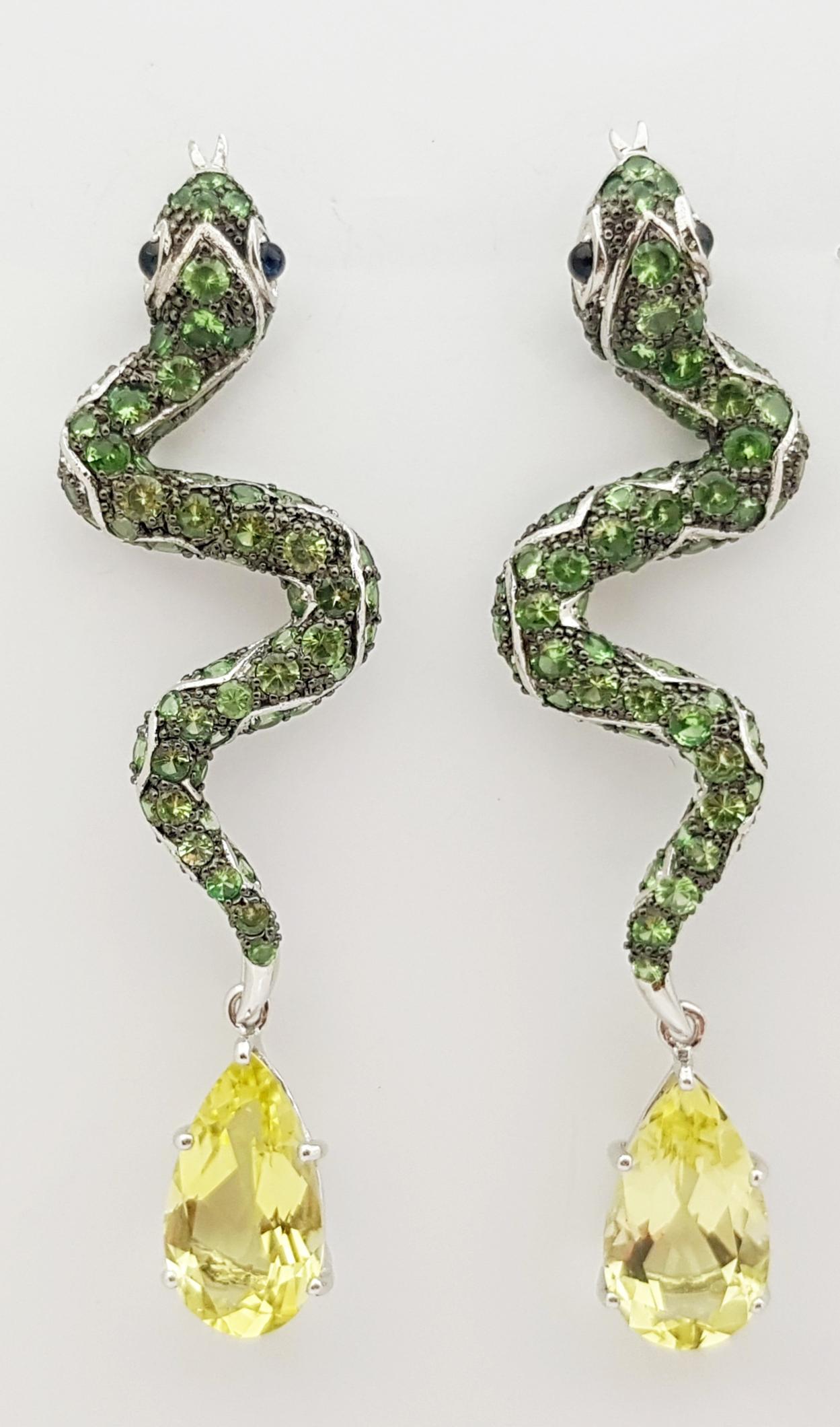Tsavorite 6.99 carats, Cabochon Blue Sapphire 0.43 carat and Lemon Quartz 13.08 carats Earrings set in Silver Settings

Width:  2.0 cm 
Length: 7.3 cm
Total Weight: 17.59 grams


*Please note that the silver setting is plated with rhodium to promote