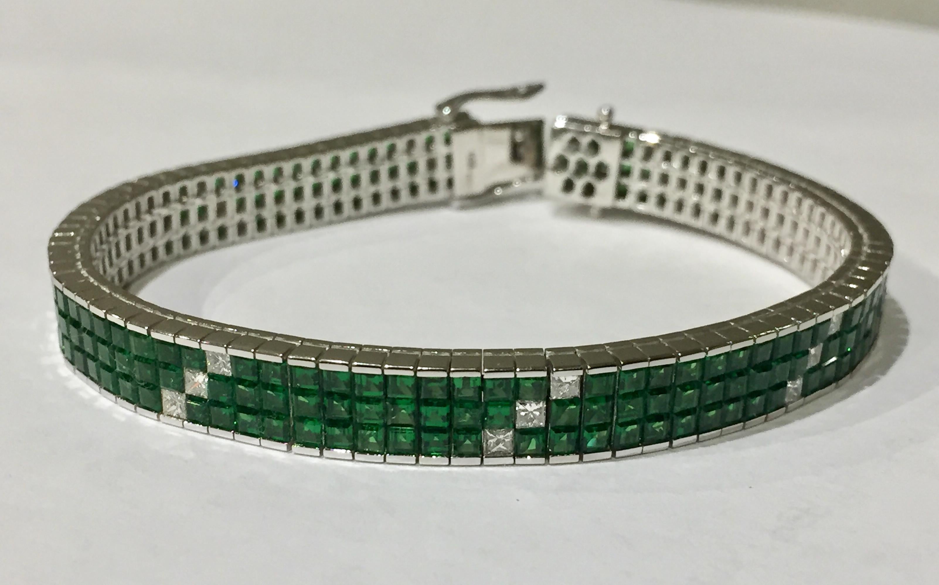 Smooth bracelet with striking vivid green tsavorites and white diamonds set invisibly in white gold 750! 
24 diamonds princess cut of total 1.14 ct. and 231 tsavorites of excellent quality of total 13.85 ct.