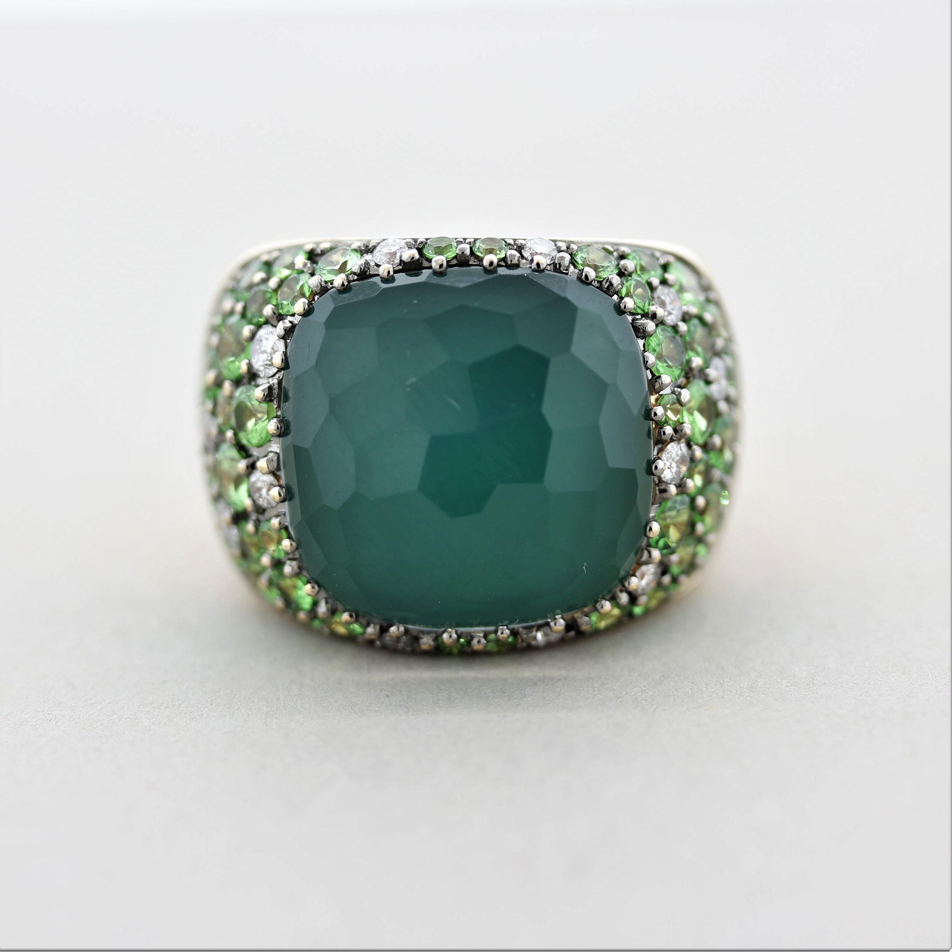 A large and impressive cocktail ring. The center stone is a 16.26 carat crystal quartz. It is set atop green enameled gold which gives the colorless crystal a green color. It is accented by bright vibrant green tsavorite that are round shaped and