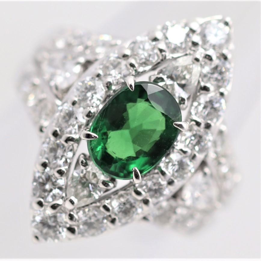 An exceptional tsavorite, weighing 1.79 carats, takes center stage of this navette-style ring. It has an intense vivid green color and a bright shiny crystal, a top stone. It is accented by 2.12 carats of round brilliant-cut diamonds and 2