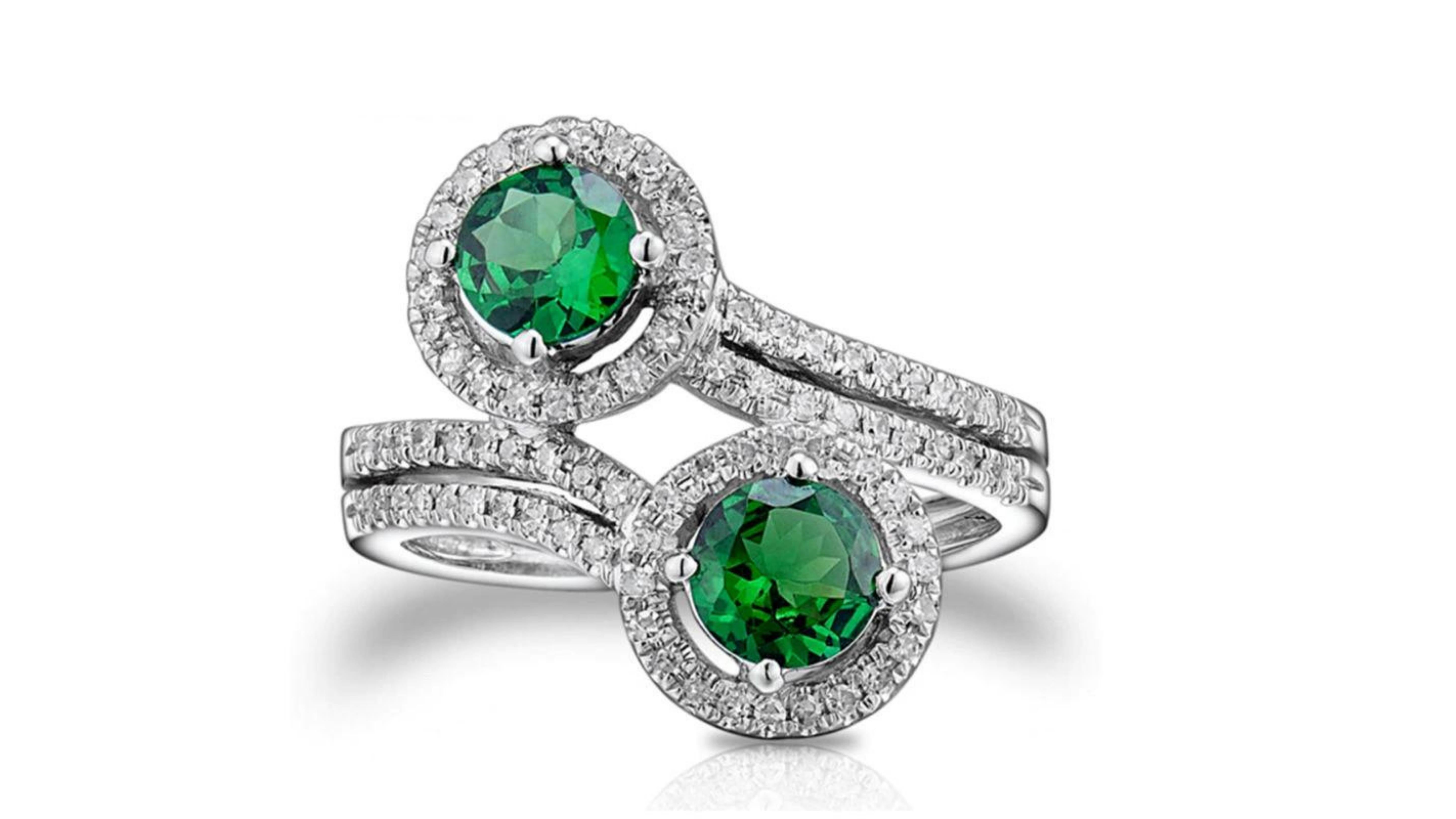 
This is a unique Tsavorite Diamond Ring 
Although named after the Tsavo East National Park in Kenya, tsavorite (sometimes called tsavolite) was first discovered in Tanzania in 1967. This gemstone became popular via a marketing campaign by Tiffany &