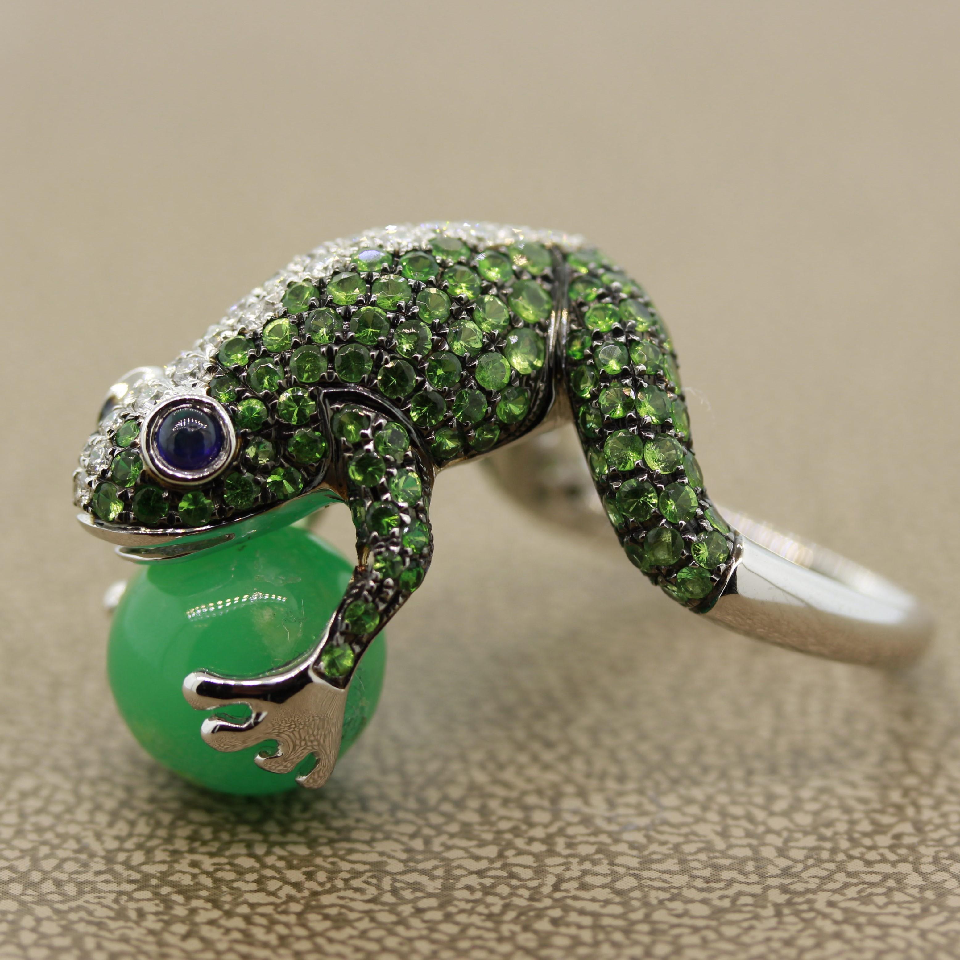 A whimsical and fine quality piece featuring 2.87 carats of round cut tsavorite, 0.35 carats of round brilliant cut diamonds and 2 blue sapphires as the frog’s eyes. It is holding a jade sphere in its hands and is made in 18k white gold.

Ring Size