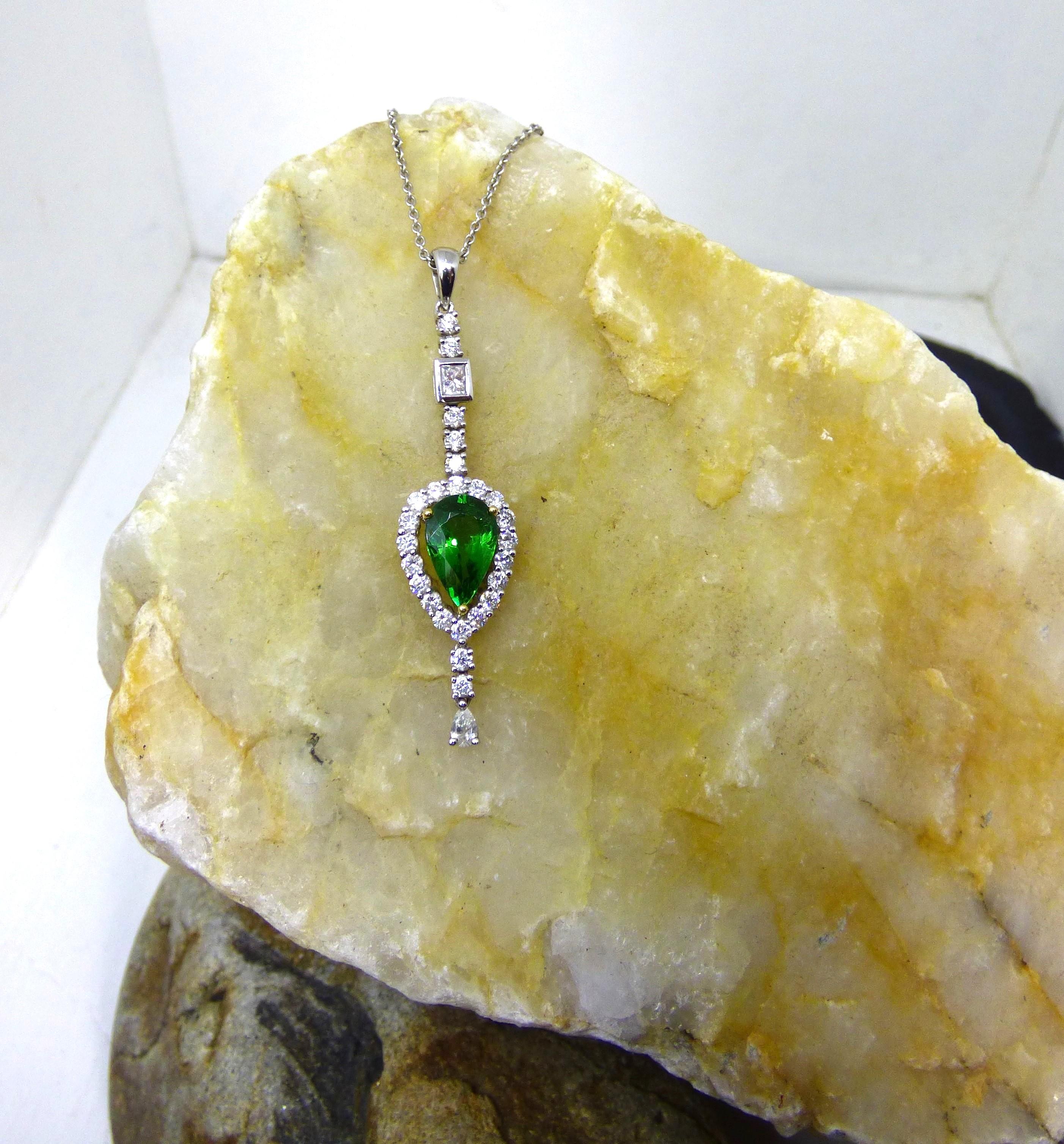 A bright green pear shaped Tsavorite Garnet is set with Diamonds in this dramatic pendant.  The Garnet is 12X7mm in size and weighs 2.24 ct.  It is set with 25 round Diamonds (.84ct.) one Princess Cut Diamond near the top (.12ct.) and a pear shaped