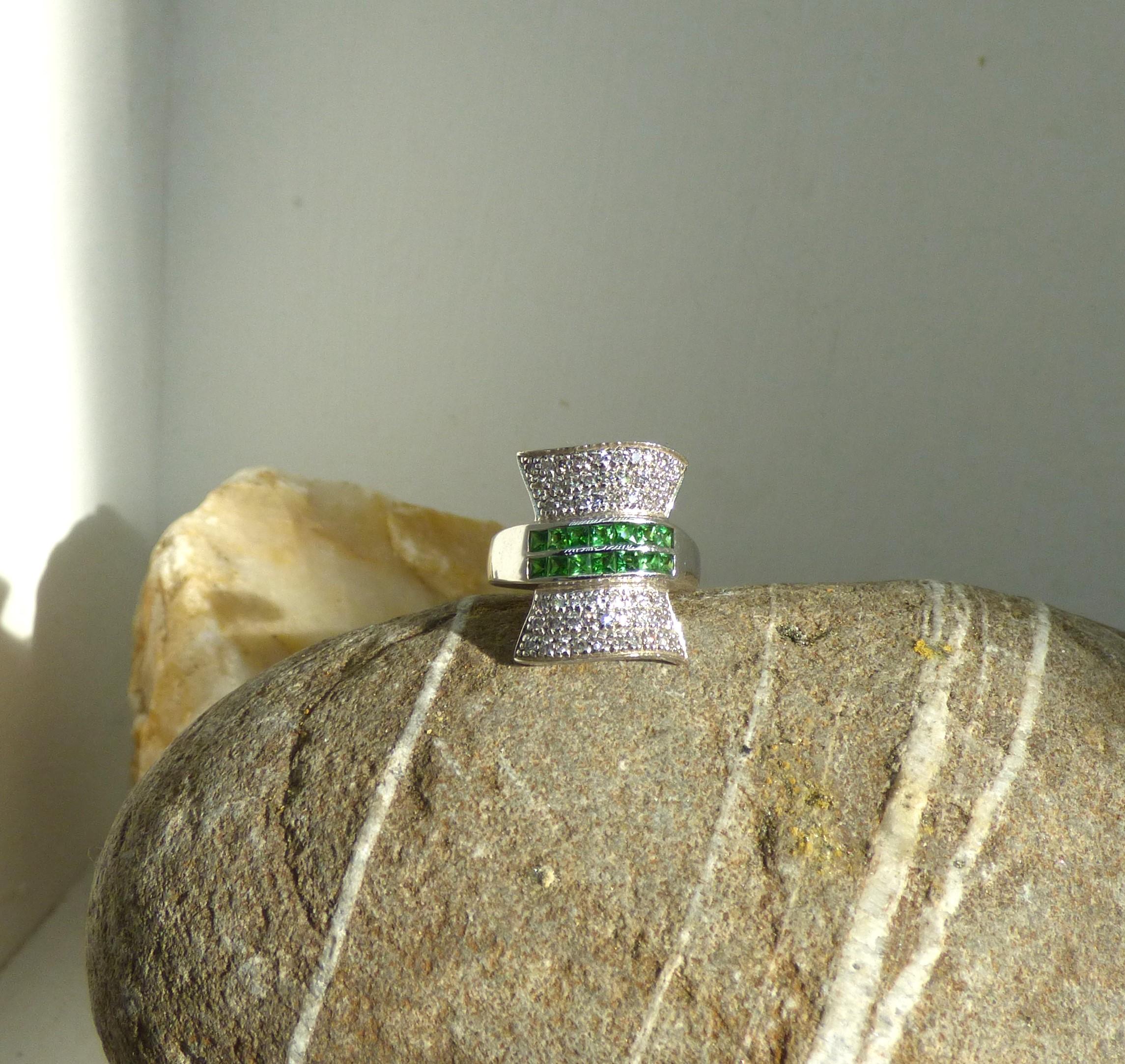 Looking for a ring that fills the finger?  Look no further! As seen in the photos, this ring would stand out on any finger.  The total front of the ring is 20X15mm.  It is set with two rows of square cut Tsavorite Garnets. The rest of the ring is