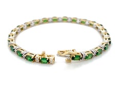 Bracciale tennis con granato tsavorite e diamanti in oro bianco e giallo 14 carati