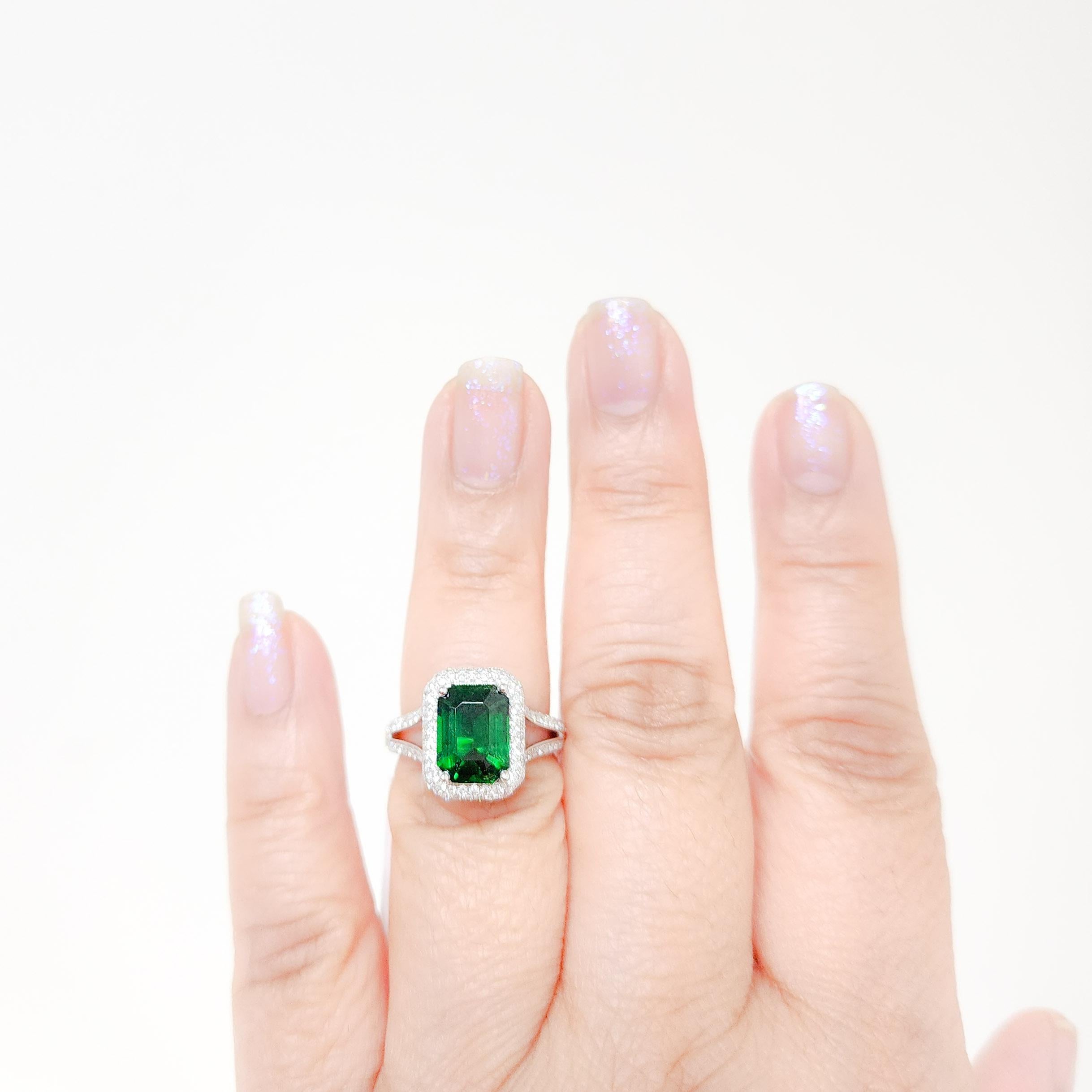 Beautiful bright 4.01 ct. tsavorite garnet emerald cut with 1.23 ct. good quality white diamond rounds.  Handmade in 18k white gold.  Ring size 6.5.