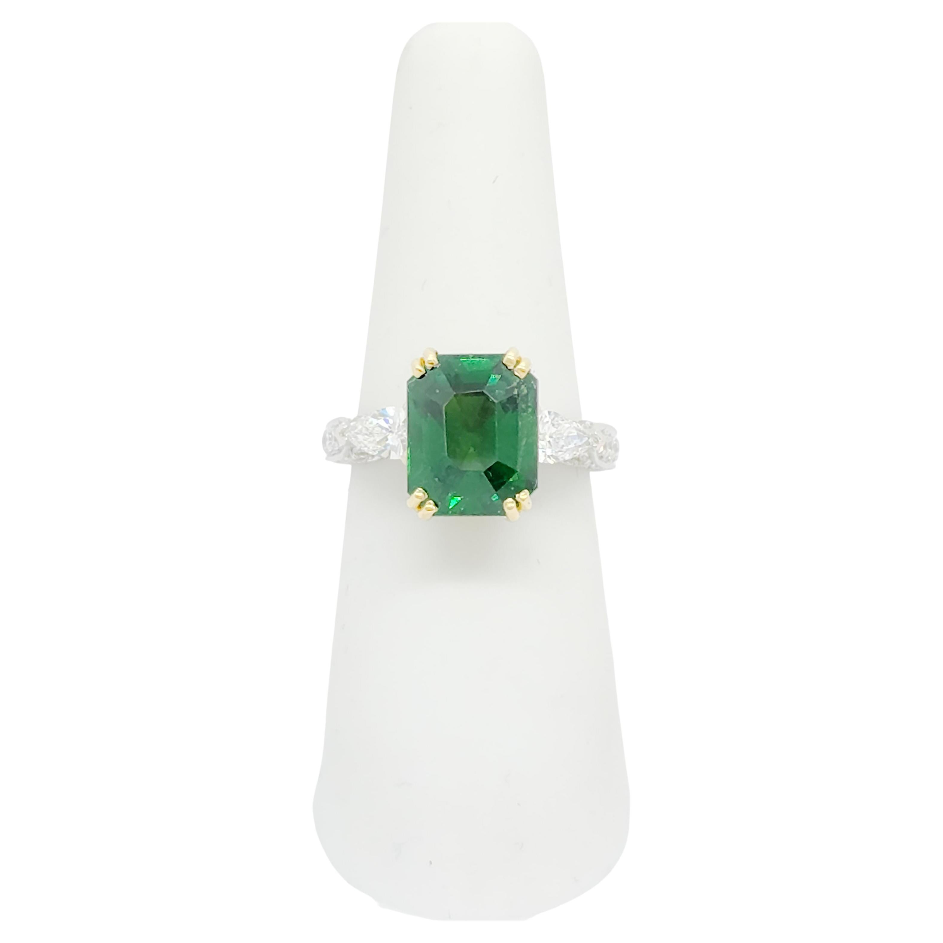 Beautiful 5.12 ct. tsavorite garnet octagon with 0.98 ct. good quality white diamond pear shapes and rounds.  Handmade in 18k yellow and white gold.  Ring size 6.5.