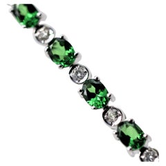 Bracciale tennis in oro con diamanti e granati di tsavorite