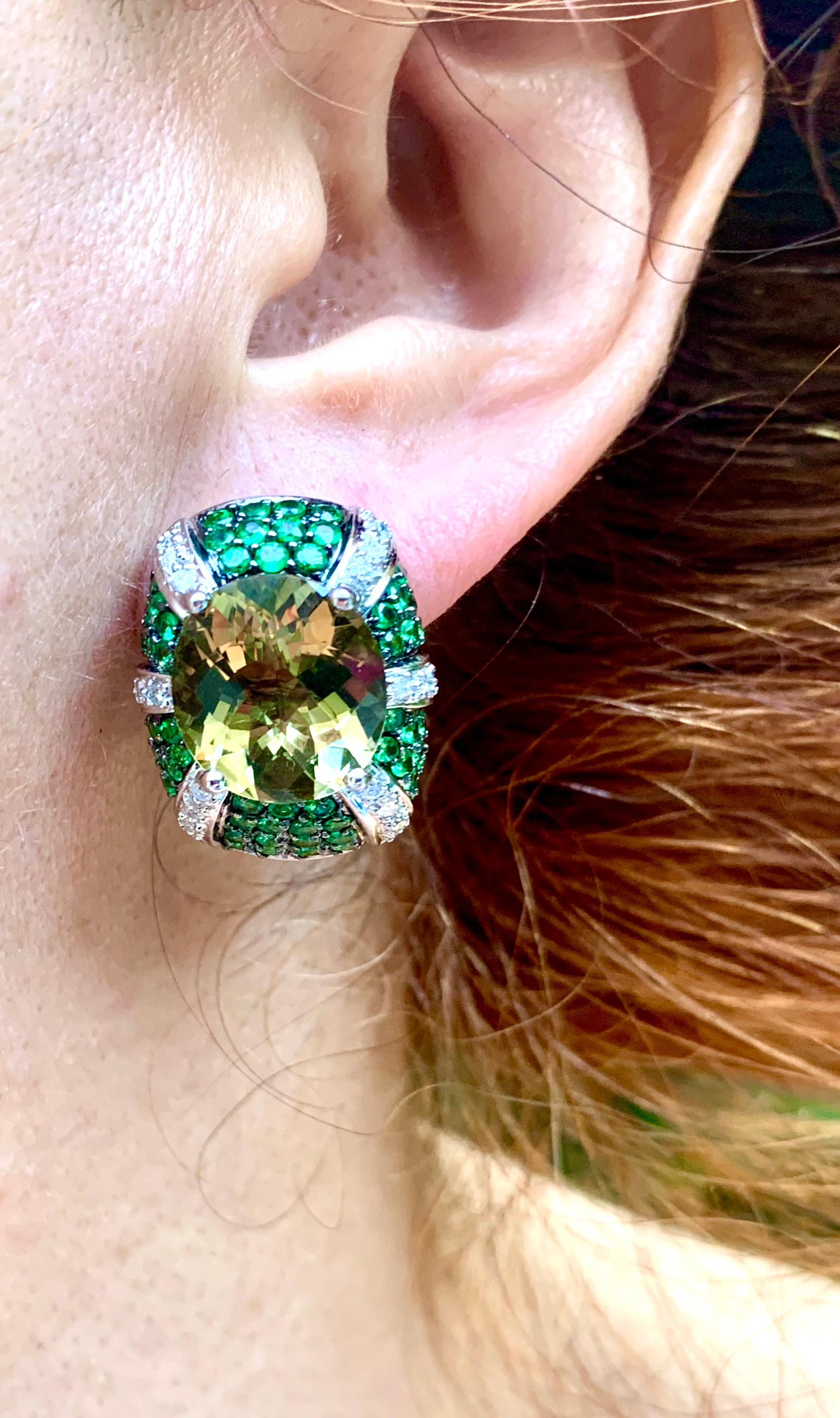 Lively, festive, eye catching Art Deco style flower form Tsavorite garnet, diamond and Lemon quartz earrings with the central stones measuring approximately 13.6mm by 11.8mm. The fine Lemon Quartz is very reminiscent of good colored diamonds at at