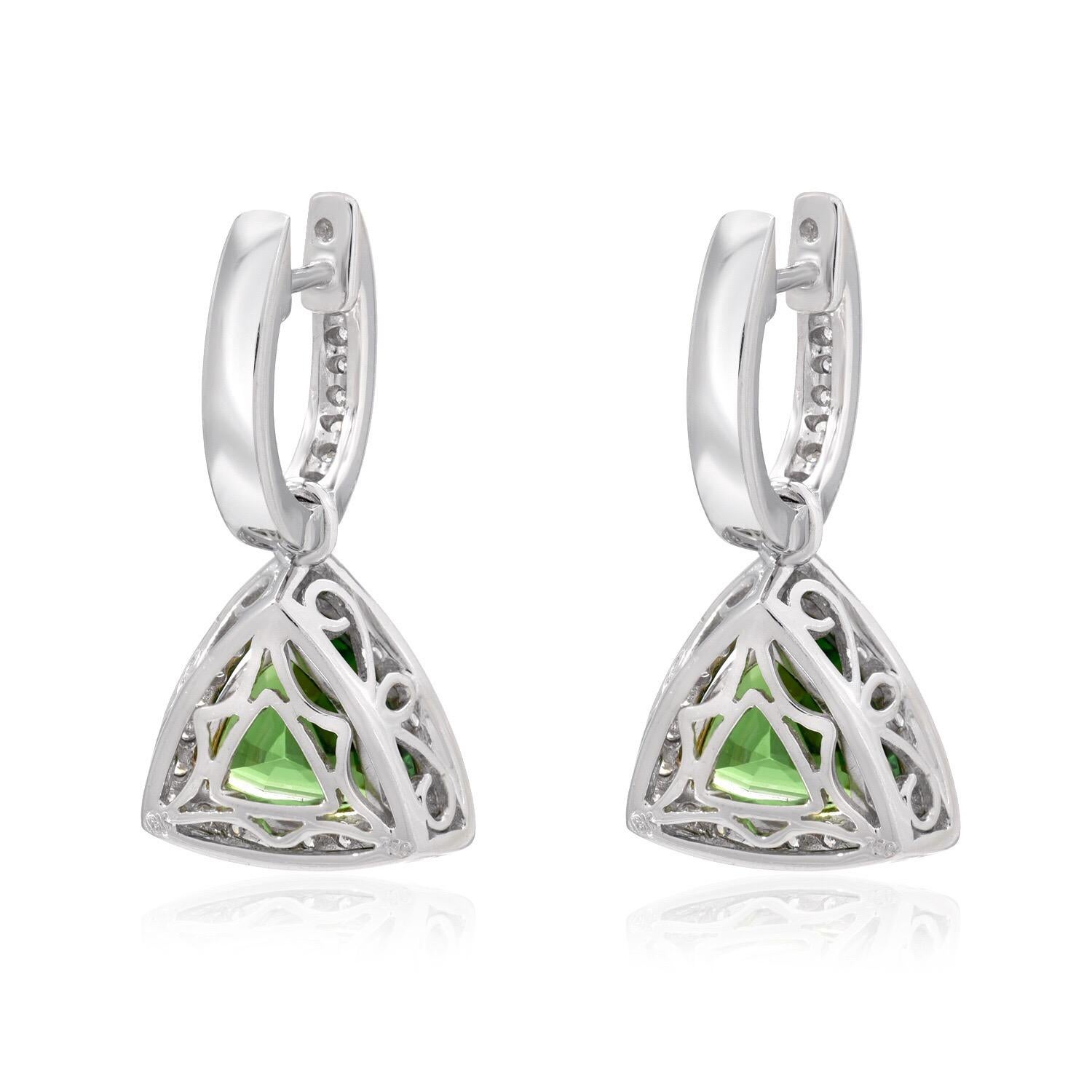 Vivid pair of Tsavorite Garnet Trillions, weighing a total of 3.50 carats, are set in these drop lever back 18K white gold earrings for women, adorned by a total of 0.45 carats of round brilliant diamonds.
0.75 inches in length.
Returns are accepted