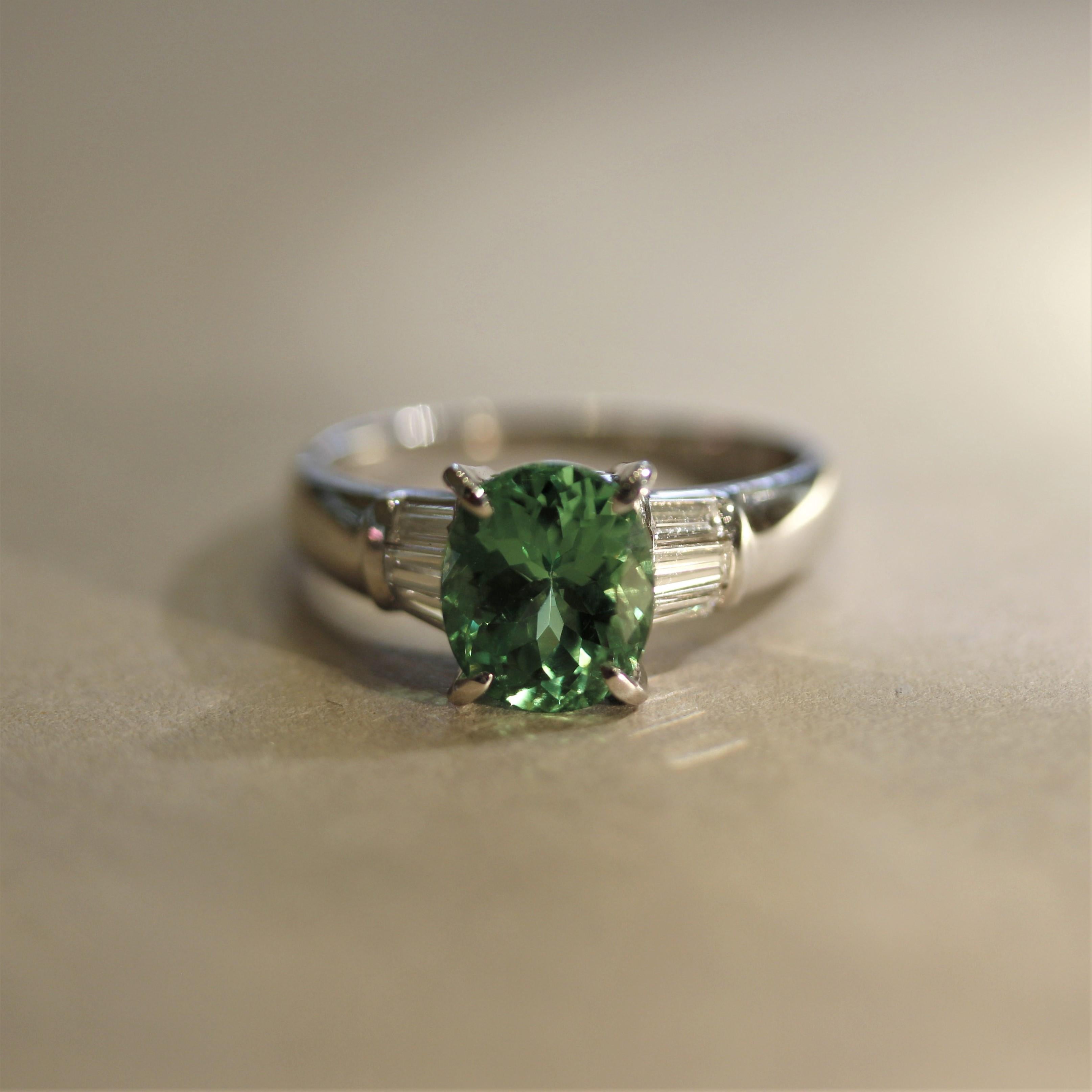 Tsavorite is a rare and beautiful green garnet only found in Tanzania and Kenya. This vibrant and brilliant tsavorite is shaped as an oval and weighs 2.51 carats (stones over 3 carats are extremely scarce). It is accented by 0.34 carats of