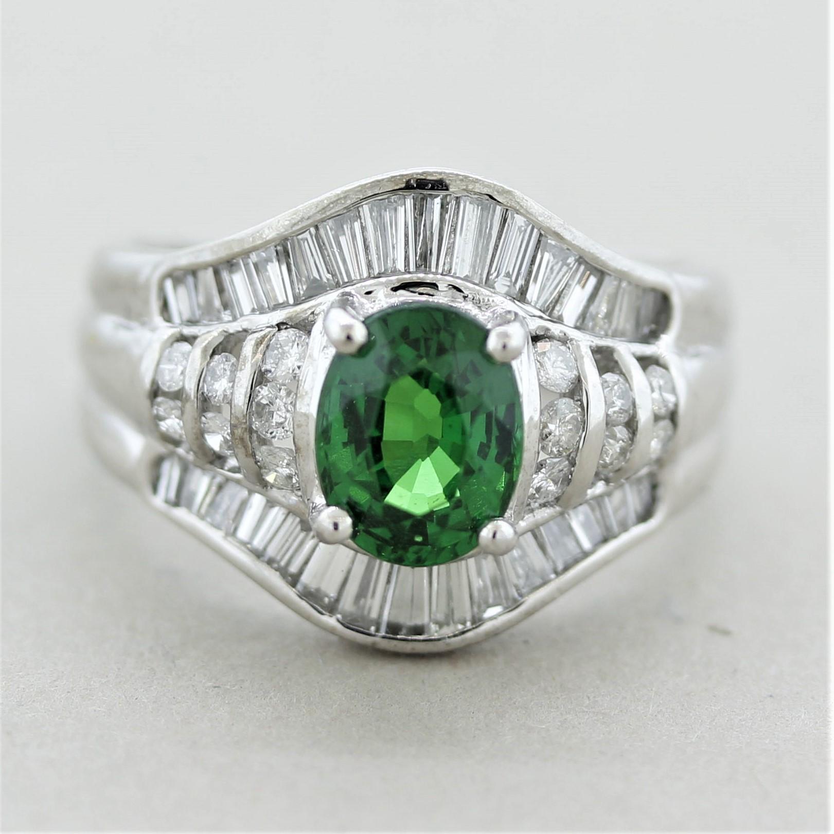 A lovely ring featuring a beautiful and fine quality tsavorite garnet. It weighs 1.50 carats and has a bright intense green color seen in top stones. It is accented by 0.90 carats of baguette and round brilliant-cut diamonds set around garnet in a