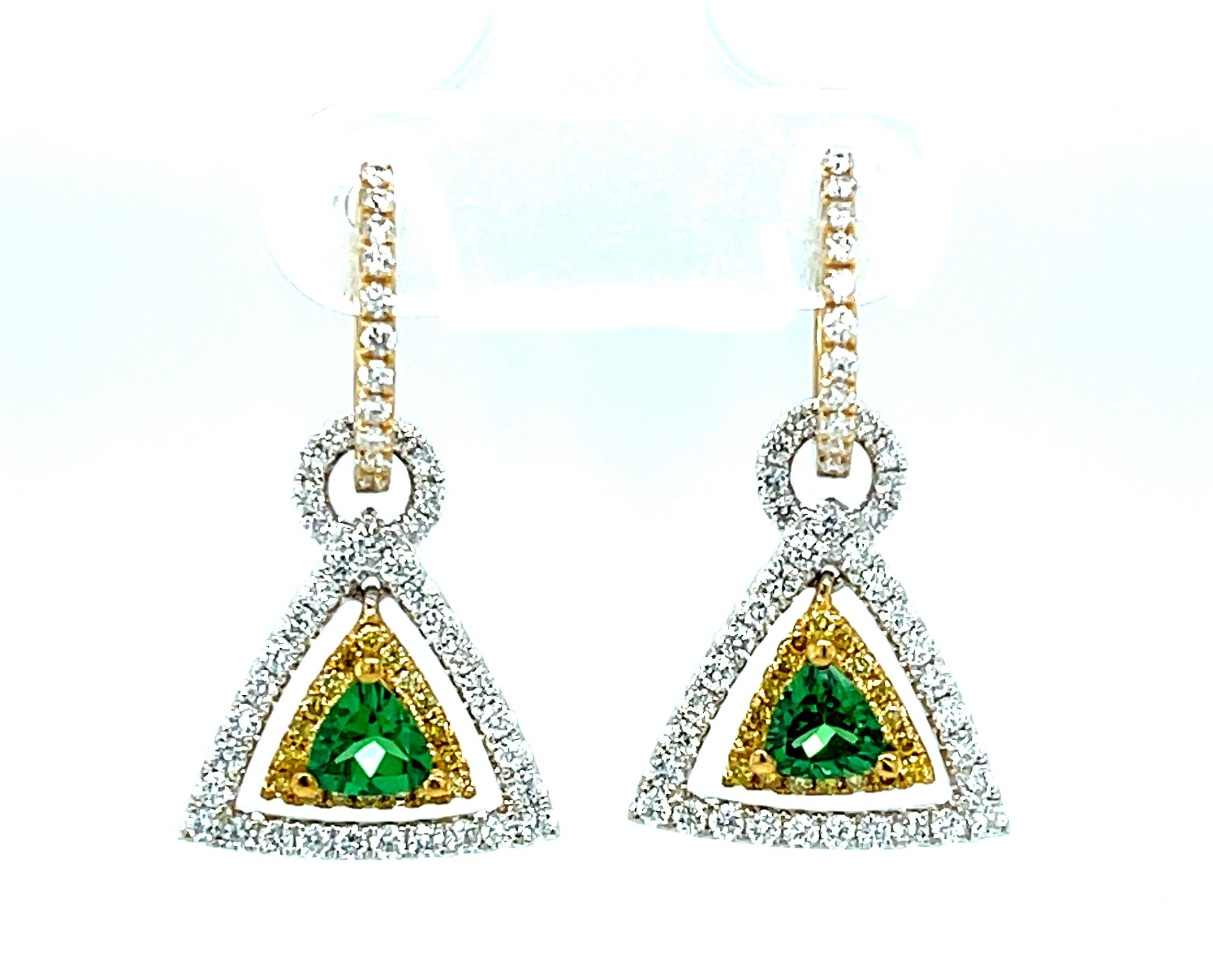 Trillion cut tsavorite garnets are set with round brilliant-cut diamonds and bright yellow sapphires in these sparkly dangle earrings. The garnets are a beautiful, brilliant grass-green color. The yellow sapphires and diamonds compliment and