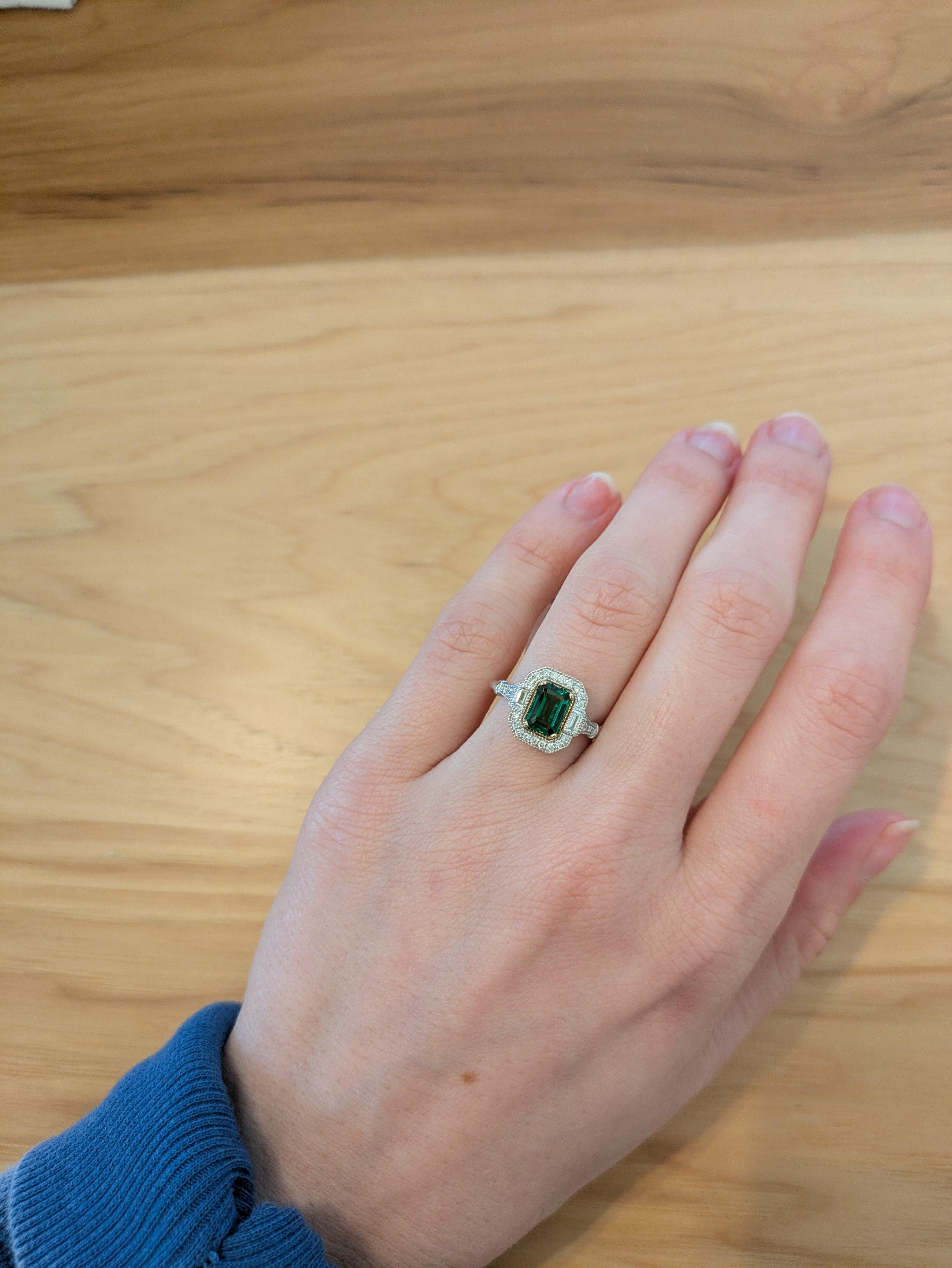 This vintage-inspired ring features a captivating tsavorite garnet, accented by stunning earth-mined diamonds, all set in radiant 14k solid gold. With its elegant design and timeless appeal, this ring is a perfect choice for those seeking a unique
