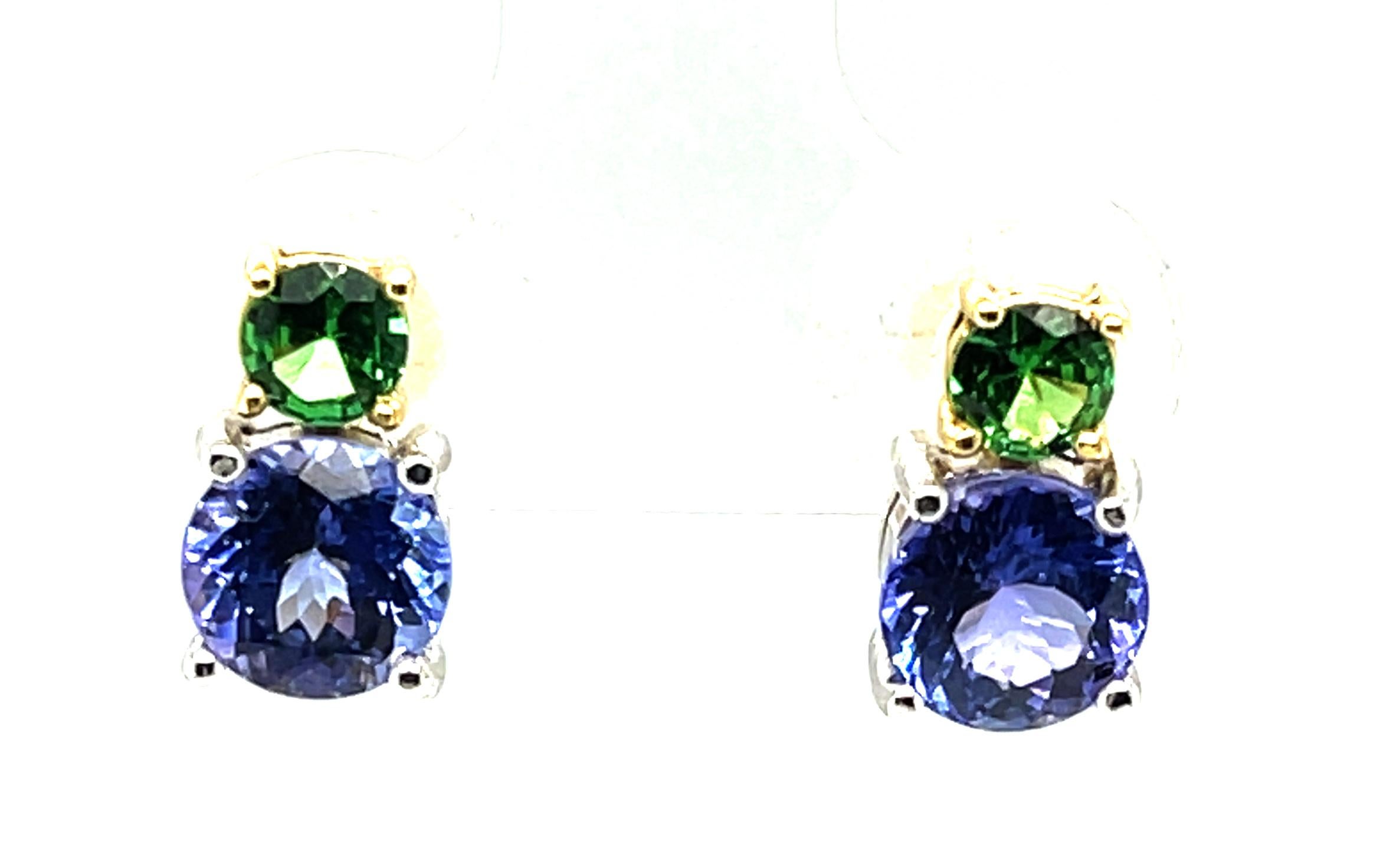 This pair of simple stud earrings are the definition of classic beauty, but with a twist! Two vivid green tsavorite garnets combined with two sparkly lavender-blue tanzanites make these color blocked earrings so unique and beautiful. The gemstones