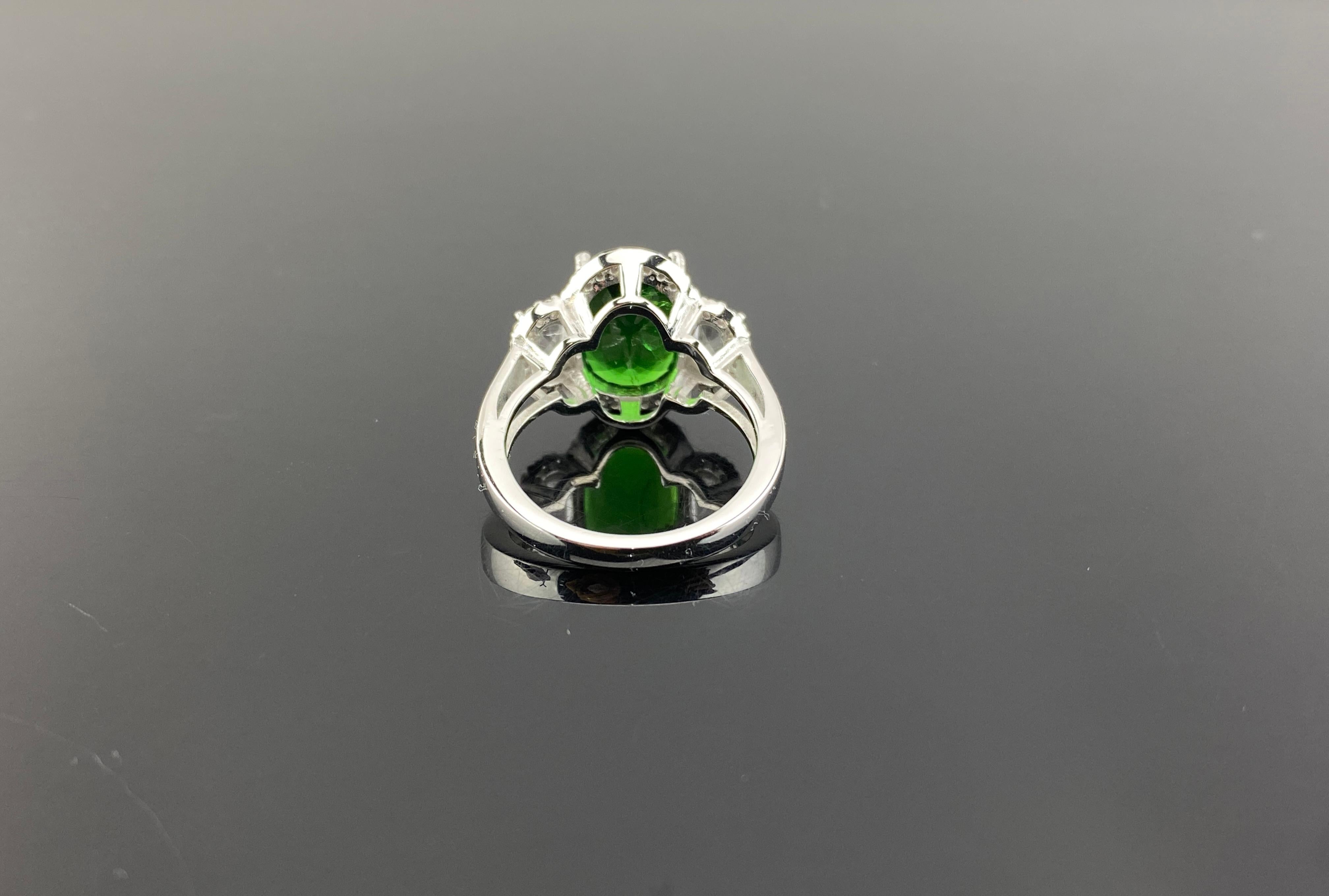 This bright, gorgeous green tsavorite garnet, named after Tsavo Park in Kenya, takes center stage in an elegant cocktail ring that will make you feel special every time you wear it. Set in 6.44 grams of 18k white gold with 2 rose cuts flanked on
