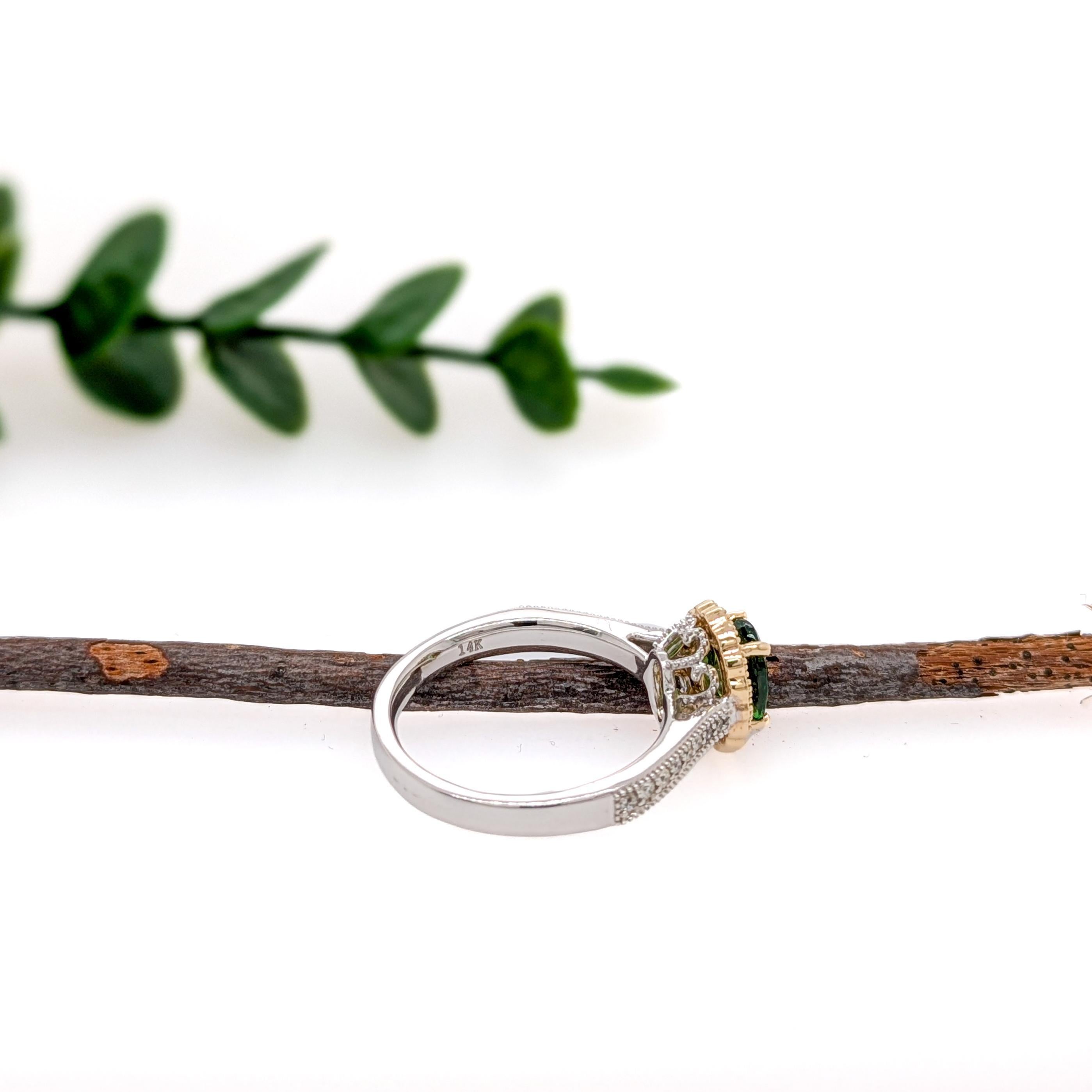 A vivid tsavorite gemstone takes center stage in this dual-tone 14K gold ring, framed by a sparkling halo of natural earth-mined diamonds. The pavé diamond shank adds extra brilliance, creating a truly timeless piece. This Tsavorite ring makes a