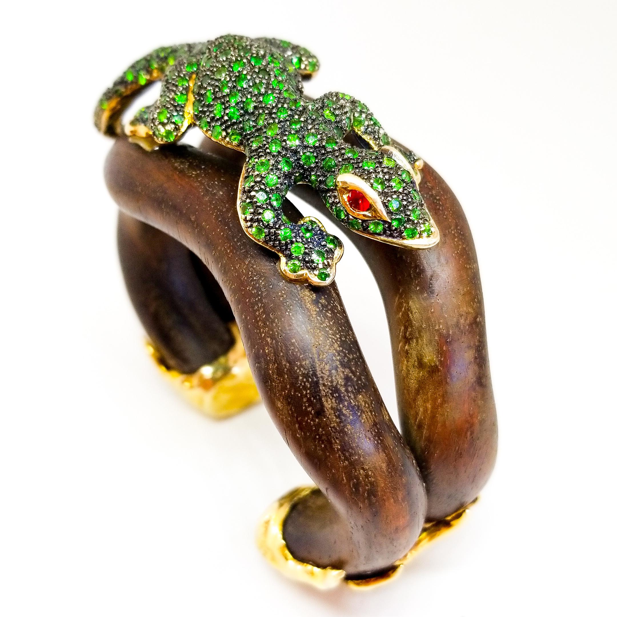 Unique.
One of a Kind Collection Piece.
Jeweled Lizard Cuff Bracelet in Silver and Gold on Wood.
This one of a kind Cuff Bracelet and Curio Showpiece will be the talk and attention of any gathering. Crafted by hand utilizing a Delicate curve of
