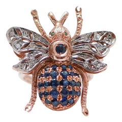 Tsavorite, saphirs, diamants, bague en or rose et argent.