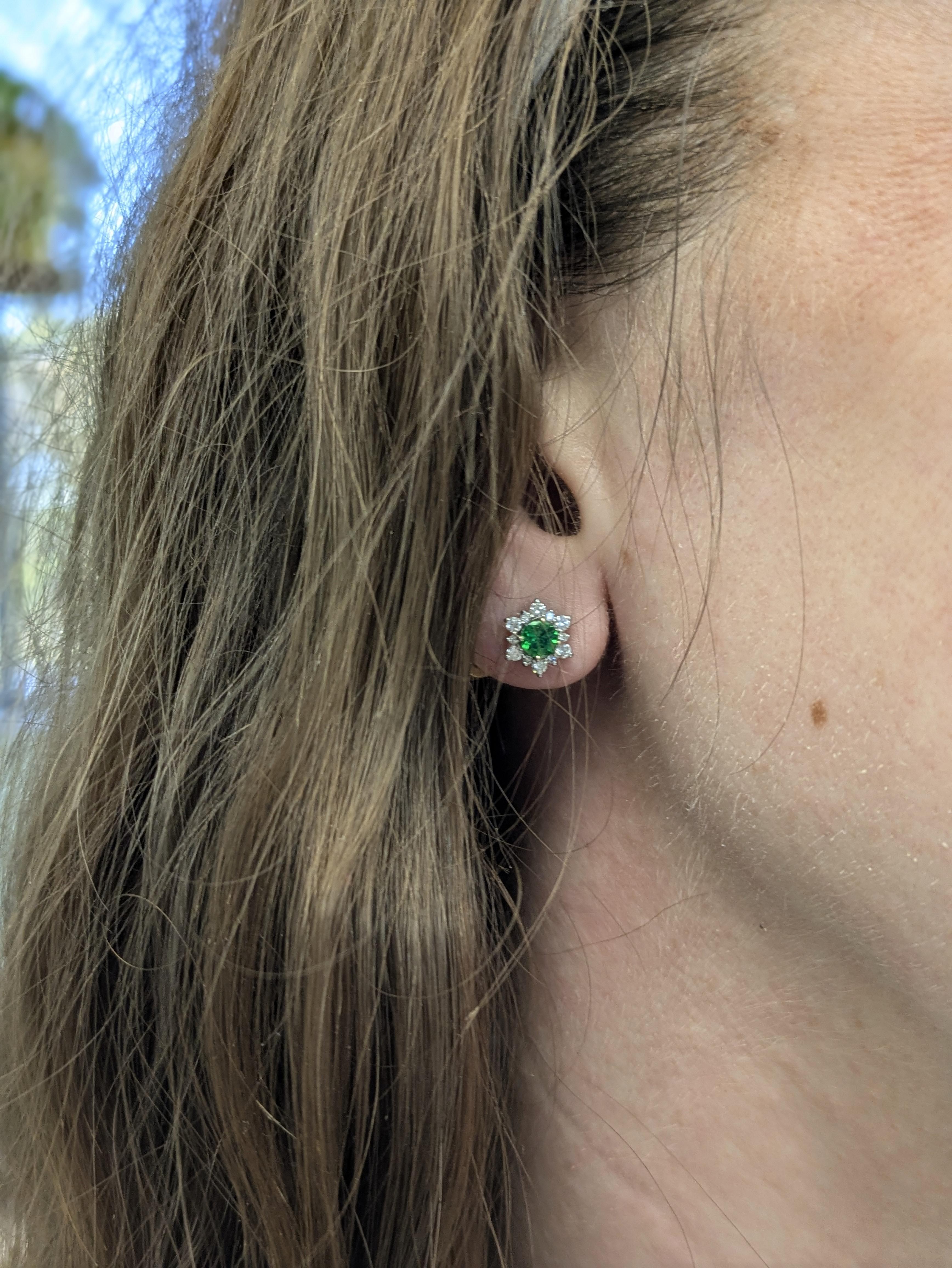 Deep-green natural tsavorite garnets set in polished 14 k white gold, flanked by sparkling diamond accents for elegant contrast. A radiant yet refined pair that pairs rich color with timeless sparkle.

“Pop on these vivid-green studs — where