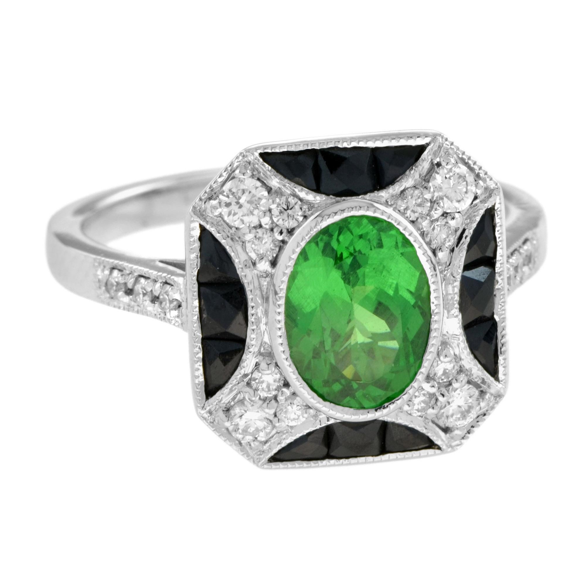 An impressive antique Art Deco inspired 1.5 carat oval tsavorite with diamond and onyx accent. The ring is crafted in 14k white gold and is currently a finger size 7. Low set, comfortable and unique this ring is outstanding. 

Ring