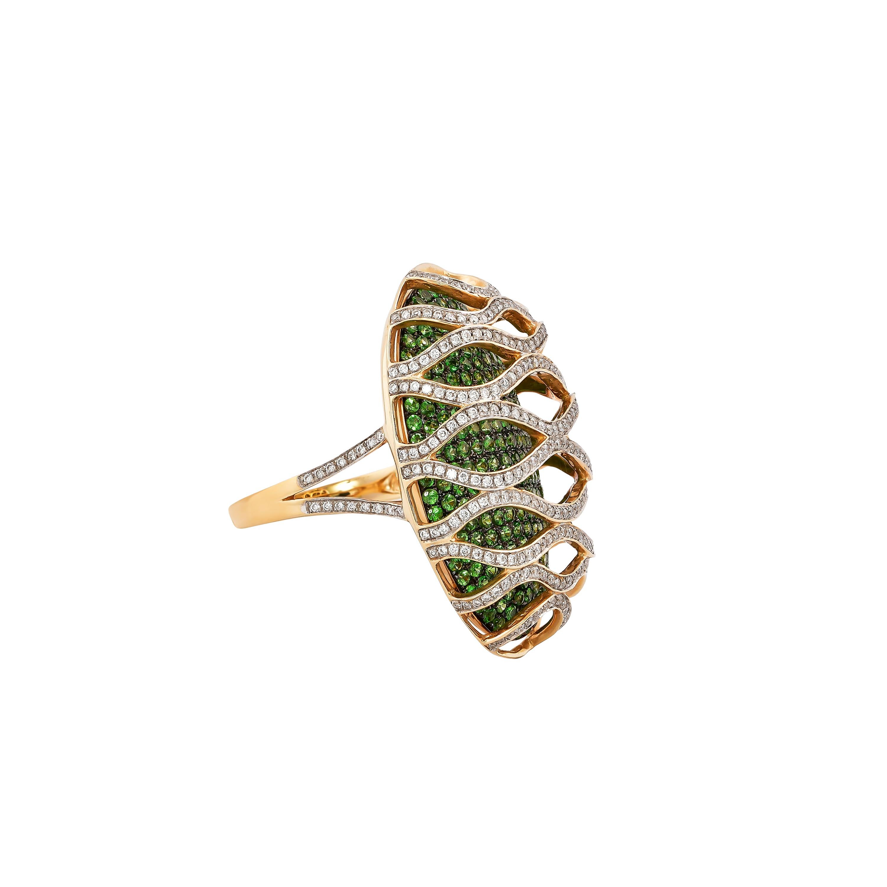 Sunita Nahata presents a collection of fancy cocktail rings with gorgeous gemstones. This ring uses a pave base of tsavorite with an architecturally constructed diamond cage on top. This unique and contrasting design presents a striking cocktail