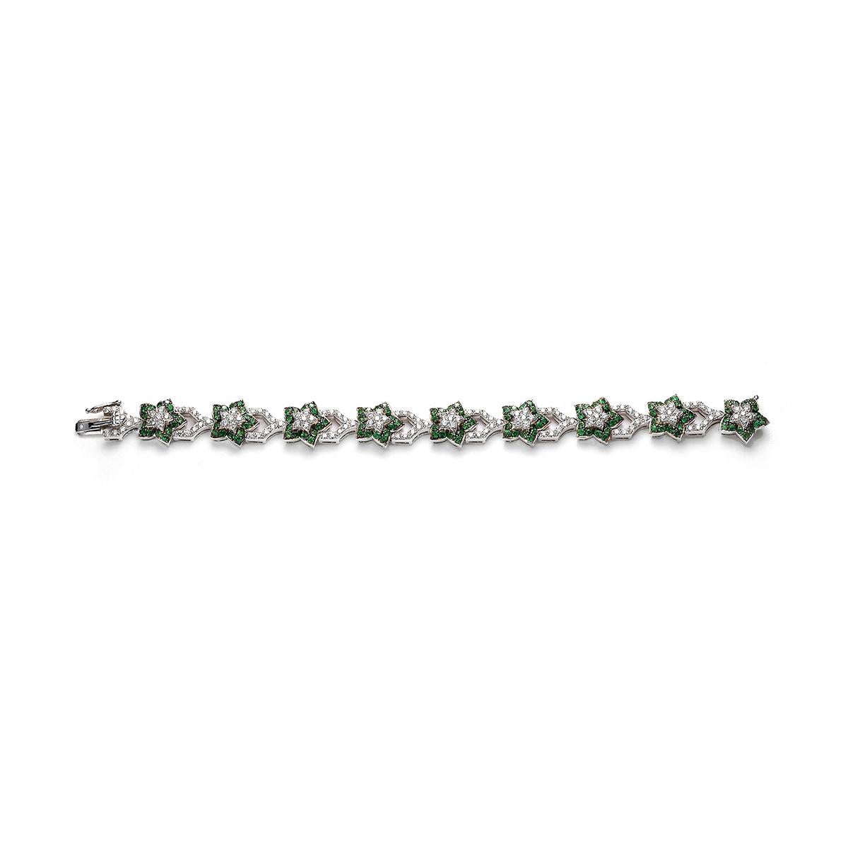 Flowers bracelet in 18kt white gold set with 135 diamonds 3.30 cts and 135 tsavorites 4.38 cts