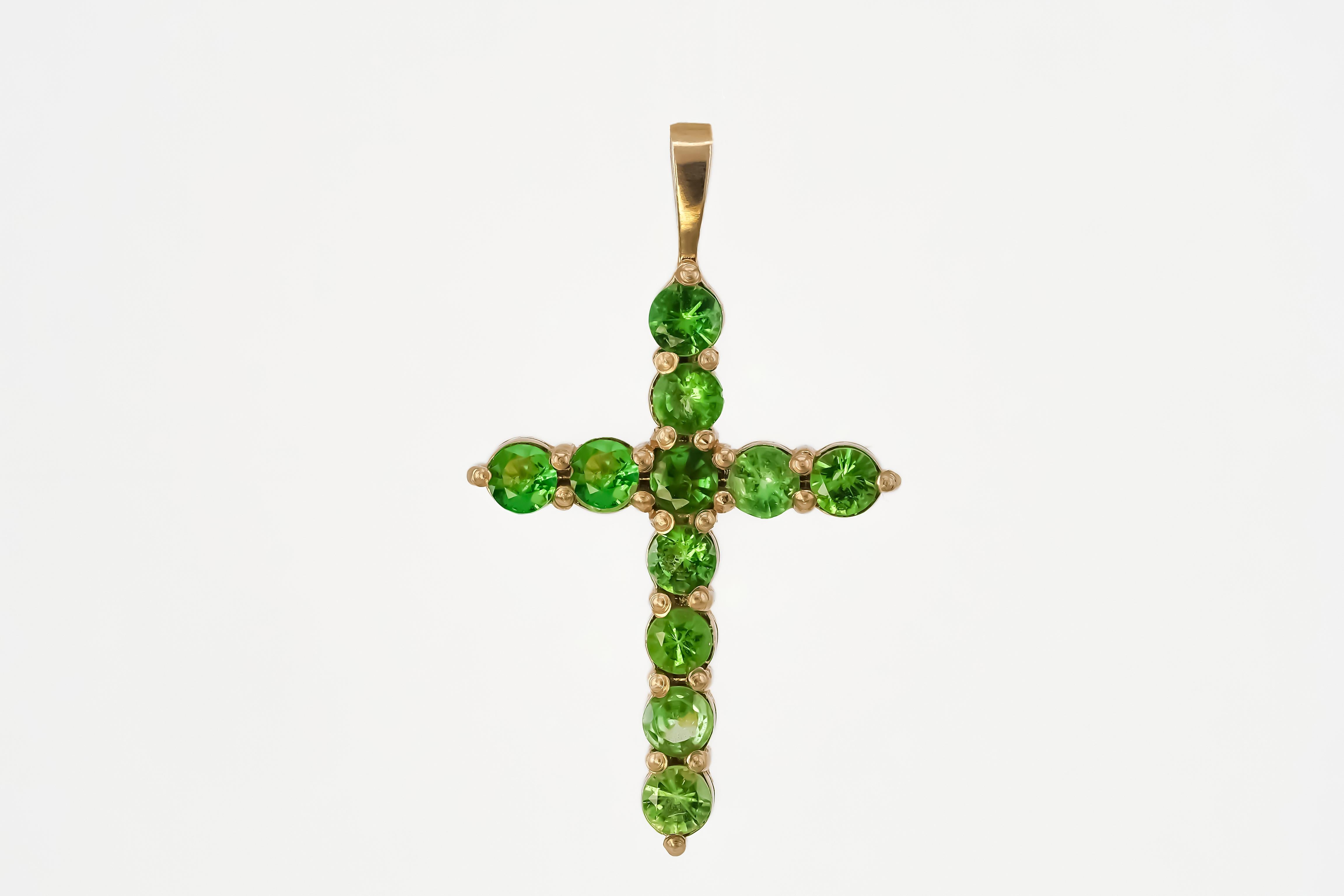 Tsavorite cross pendant. Gold cross pendant. Green garnet cross pendant in 14k gold. Gold cross pendant with tsavorites

Weight: 1.2 g.
Gold - 14k gold 
Size: 23.4x14 mm 
Stones:
Set with tsavorites, color - green
Round cut, aprox 0.88 ct. in total