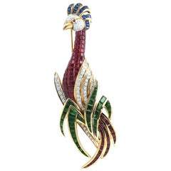 Broche oiseau en or 18 carats avec tsavorites, rubis, saphir bleu et diamants 