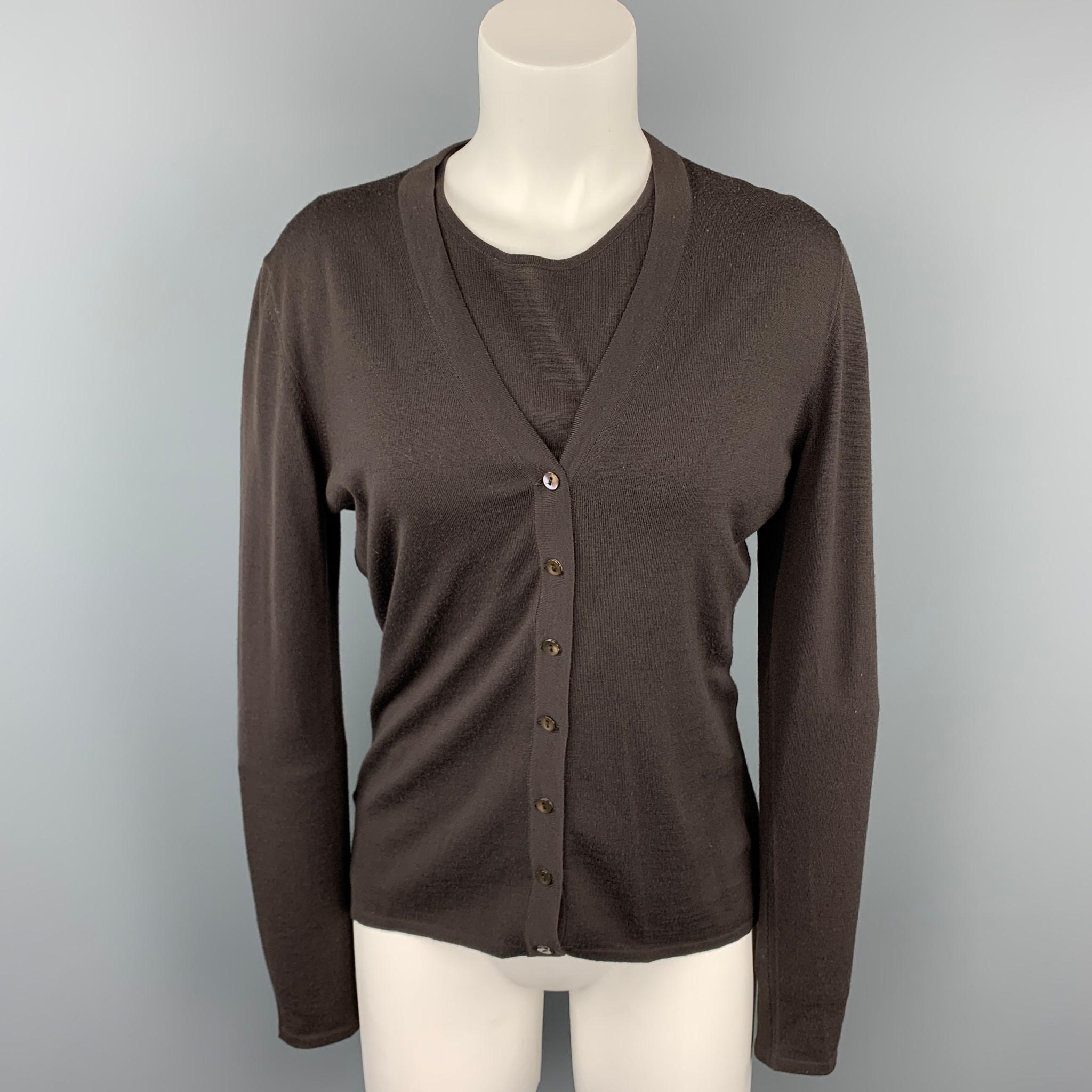 TSE cardigan comes in a brown knitted wool featuring a v-neck and a buttoned closure. Short sleeve pullover sold separately. Made in Italy.

Very Good Pre-Owned Condition.
Marked: L

Measurements:

Shoulder: 18 in.
Bust: 38 in.
Sleeve: 24.5