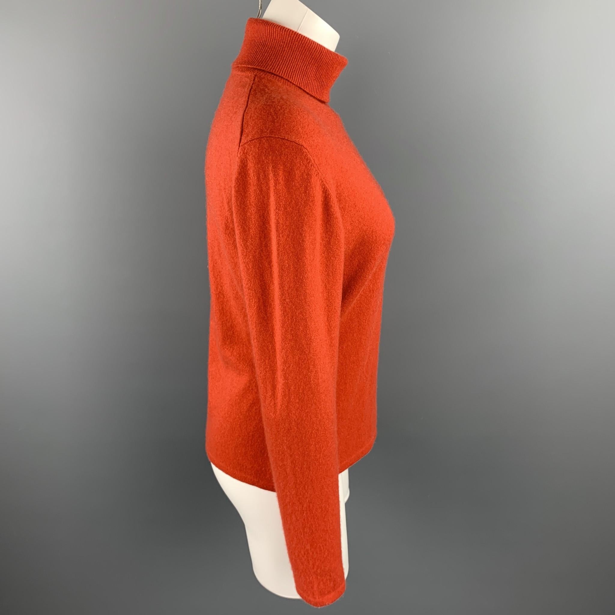 TSE sweater comes in a coral knitted cashmere featuring a turtleneck style.

Very Good Pre-Owned Condition.
Marked: No size marked

Measurements:

Shoulder: 18 in. 
Bust: 38 in. 
Sleeve: 24 in. 
Length: 22 in. 

SKU: 92737
Category: Sweater

More