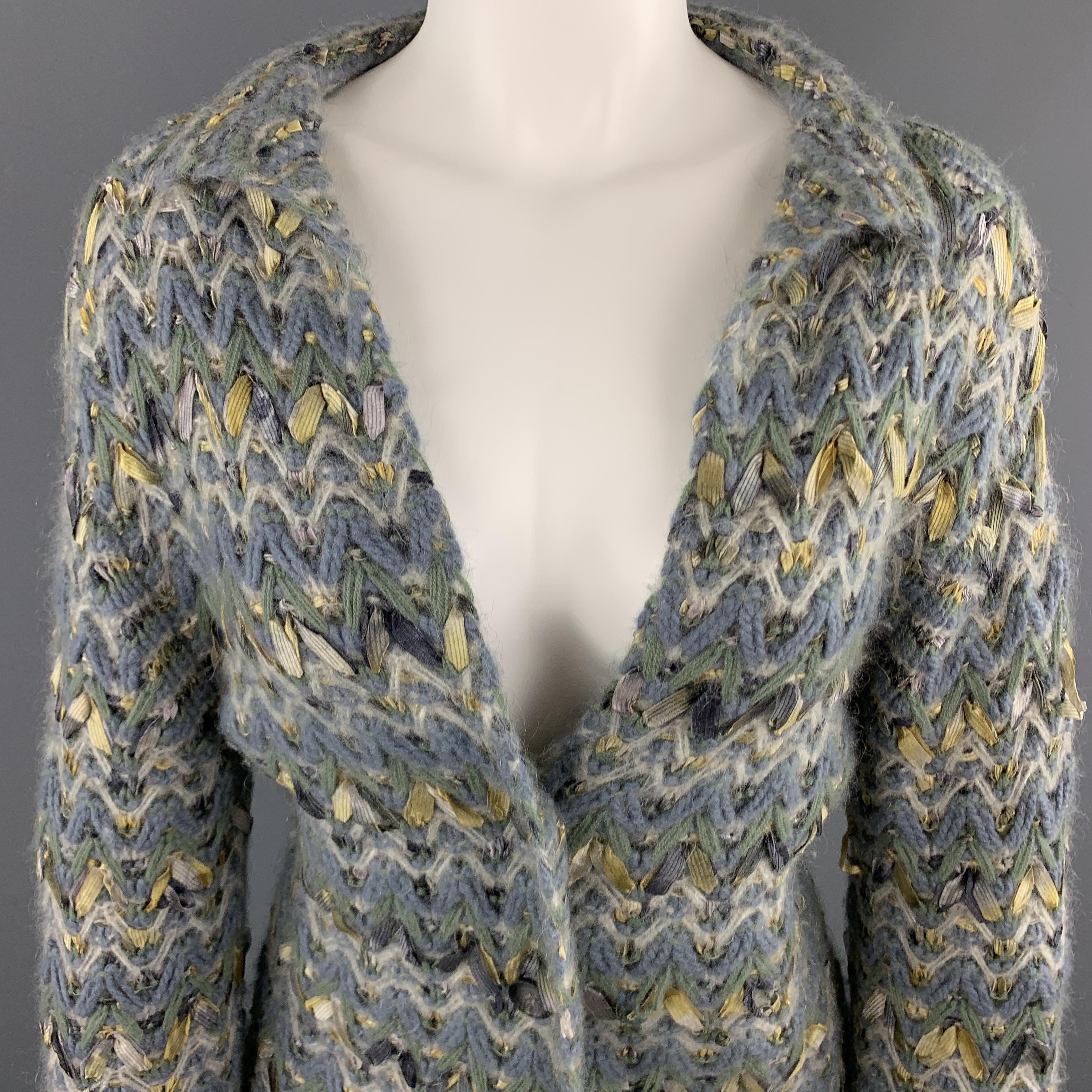 TSE cardigan jacket comes in muted blue and green chevron chunky knit with ribbon woven throughout, collared lapel, and three button front. 

Excellent Pre-Owned Condition.
Marked: M

Measurements:

Shoulder: 17 in.
Bust: 36 in.
Sleeve: 26