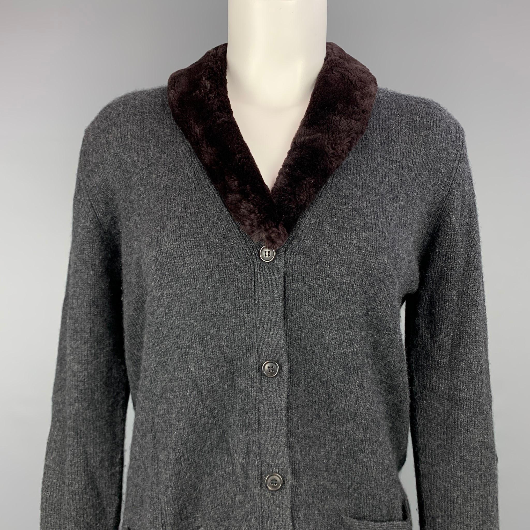 TSE cardigan comes in a charcoal knitted cashmere featuring a fur trim, front pockets, and a buttoned closure.

Very Good Pre-Owned Condition.
Marked: S

Measurements:

Shoulder: 16 in.
Bust: 40 in.
Sleeve: 26 in.
Length: 25 in. 