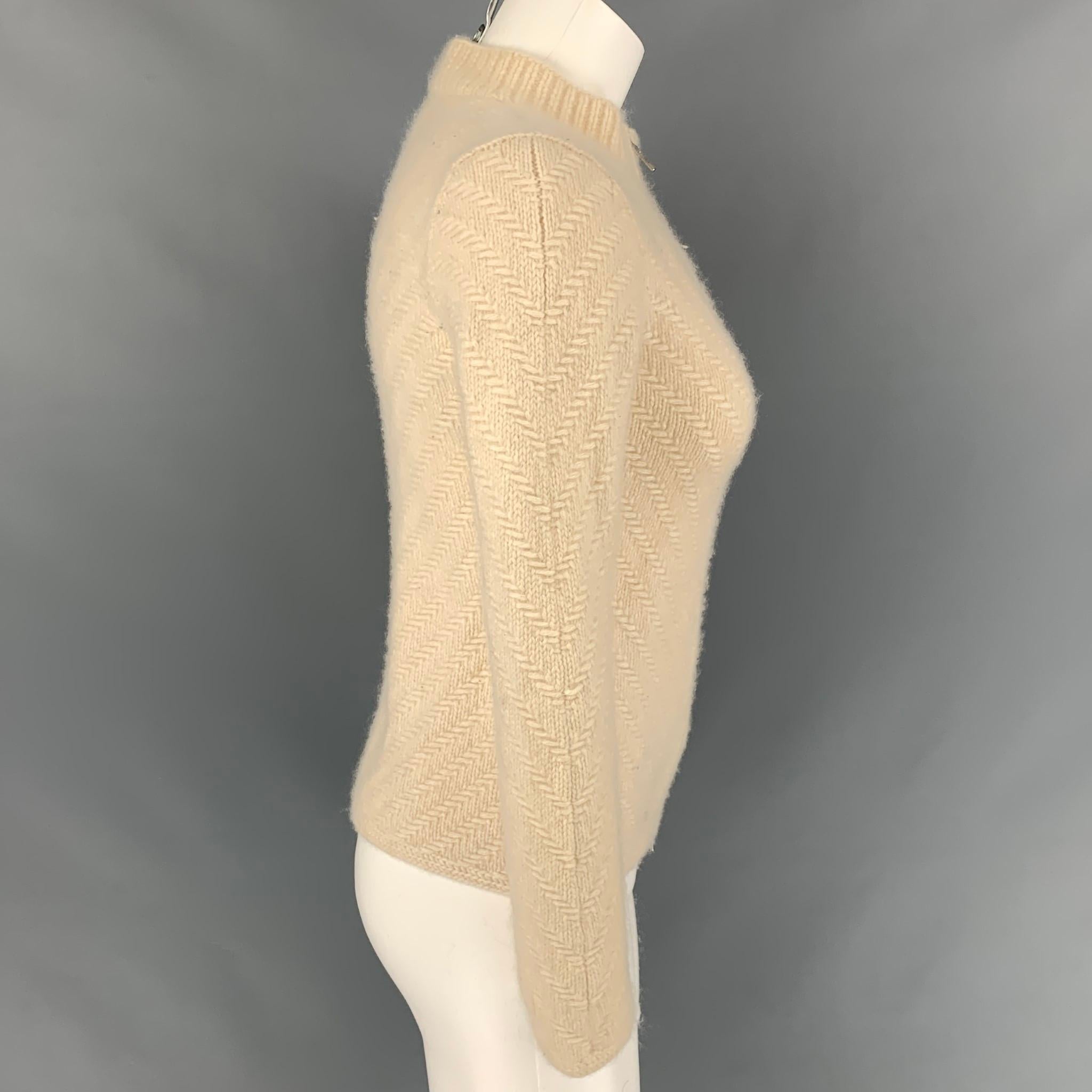 TSE cardigan comes in a cram knitted cashmere featuring a high collar and a zip up closure. 

Very Good Pre-Owned Condition.
Marked: XS
Original Retail Price: $795.00

Measurements:

Shoulder: 15 in.
Bust: 30 in.
Sleeve: 24 in.
Length: 20 in. 