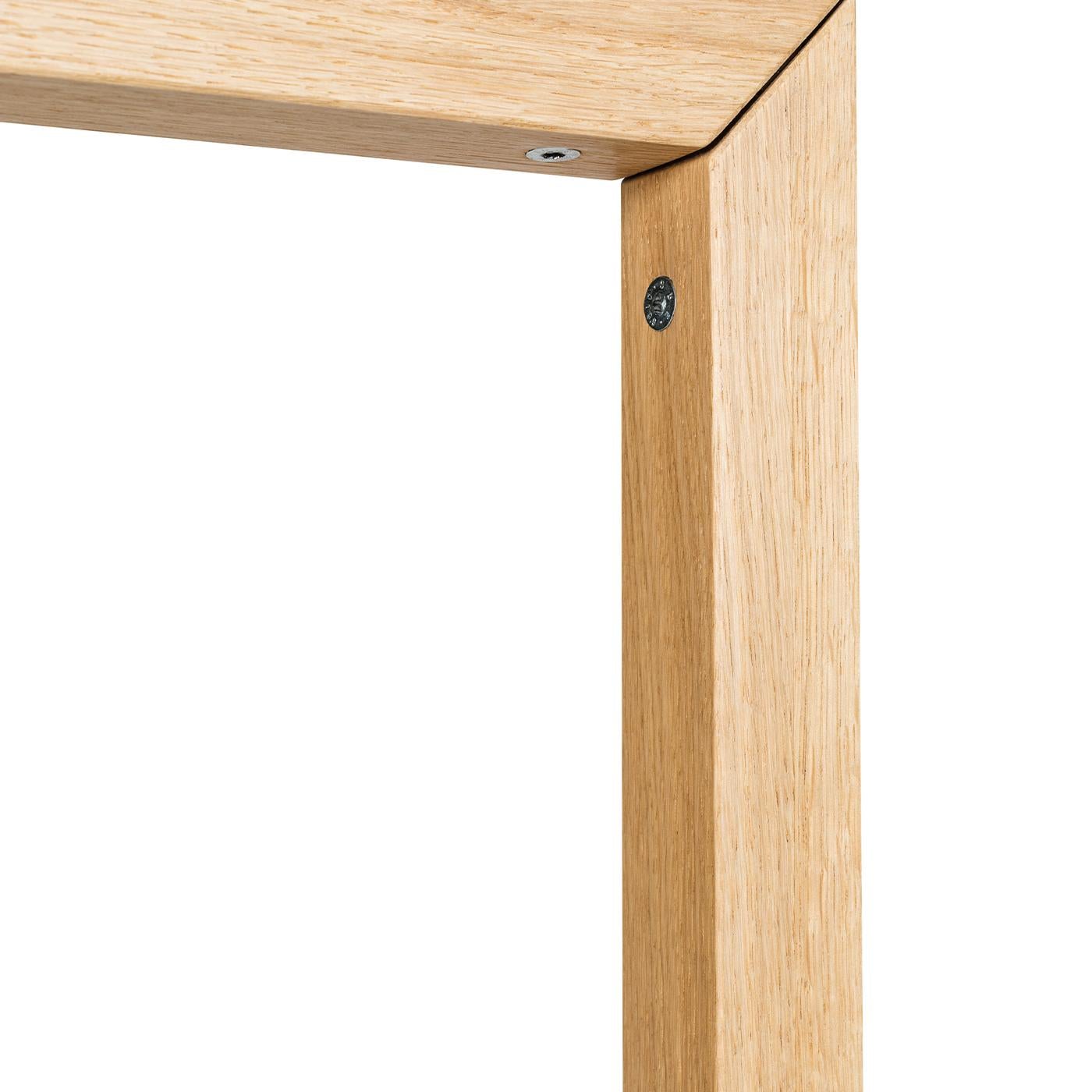 This simple, elegant floor lamp will add a touch of light to any home or office space. The lamp, which has a streamlined body in solid natural oak and rests on a round oak base, is coated in a water-based varnish. A lampshade in jute, but available