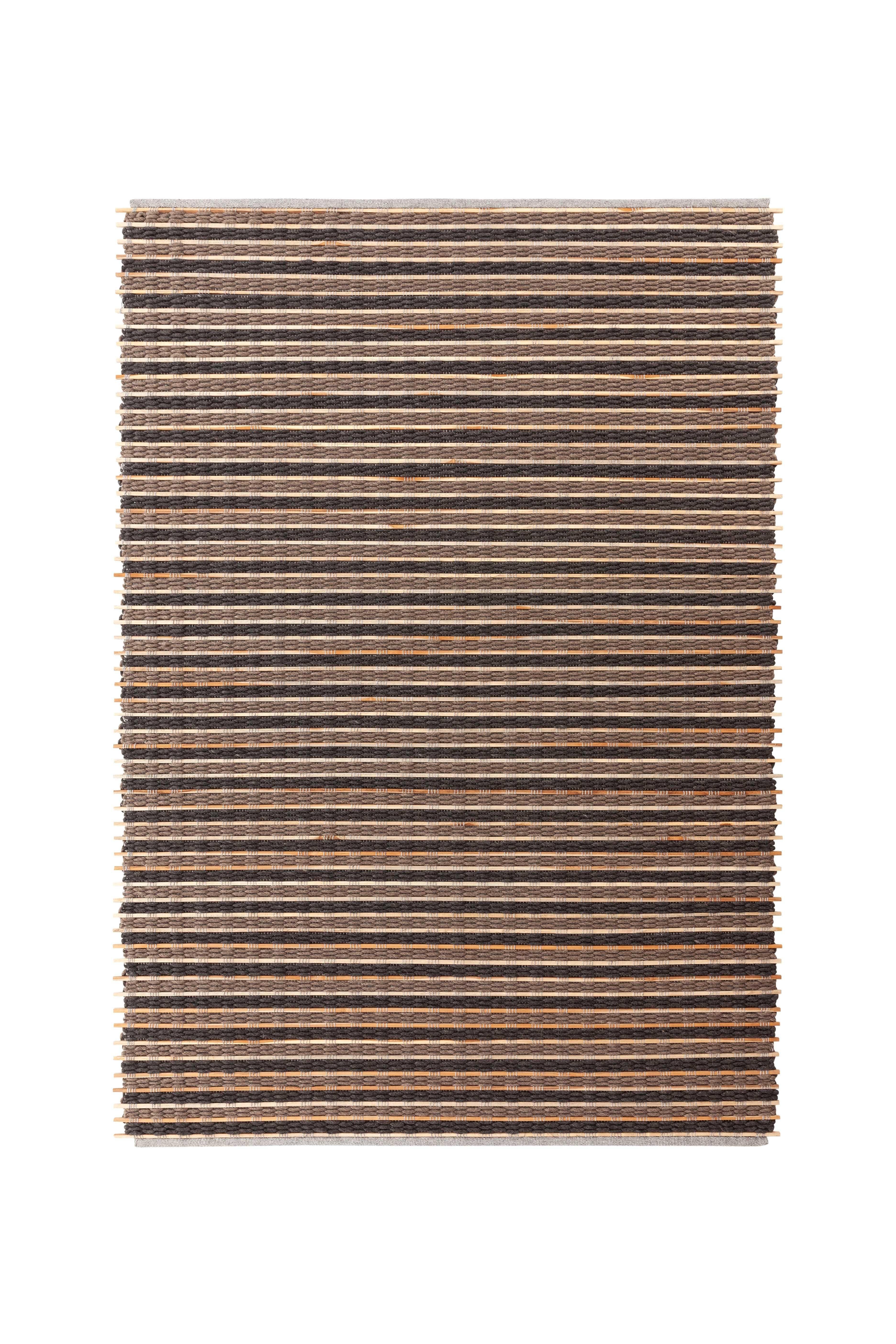 Tsuchi Brown Goz Rug by Gandia Blasco
Design by Kengo Kuma
Dimensions: W 176 x H 240 cm. 
Materials: Wool, teak wood. 
Weight: 11,86 kg

Passion for life outdoors, a dream come true on the edge of a cliff in the north of Ibiza. The elemental and