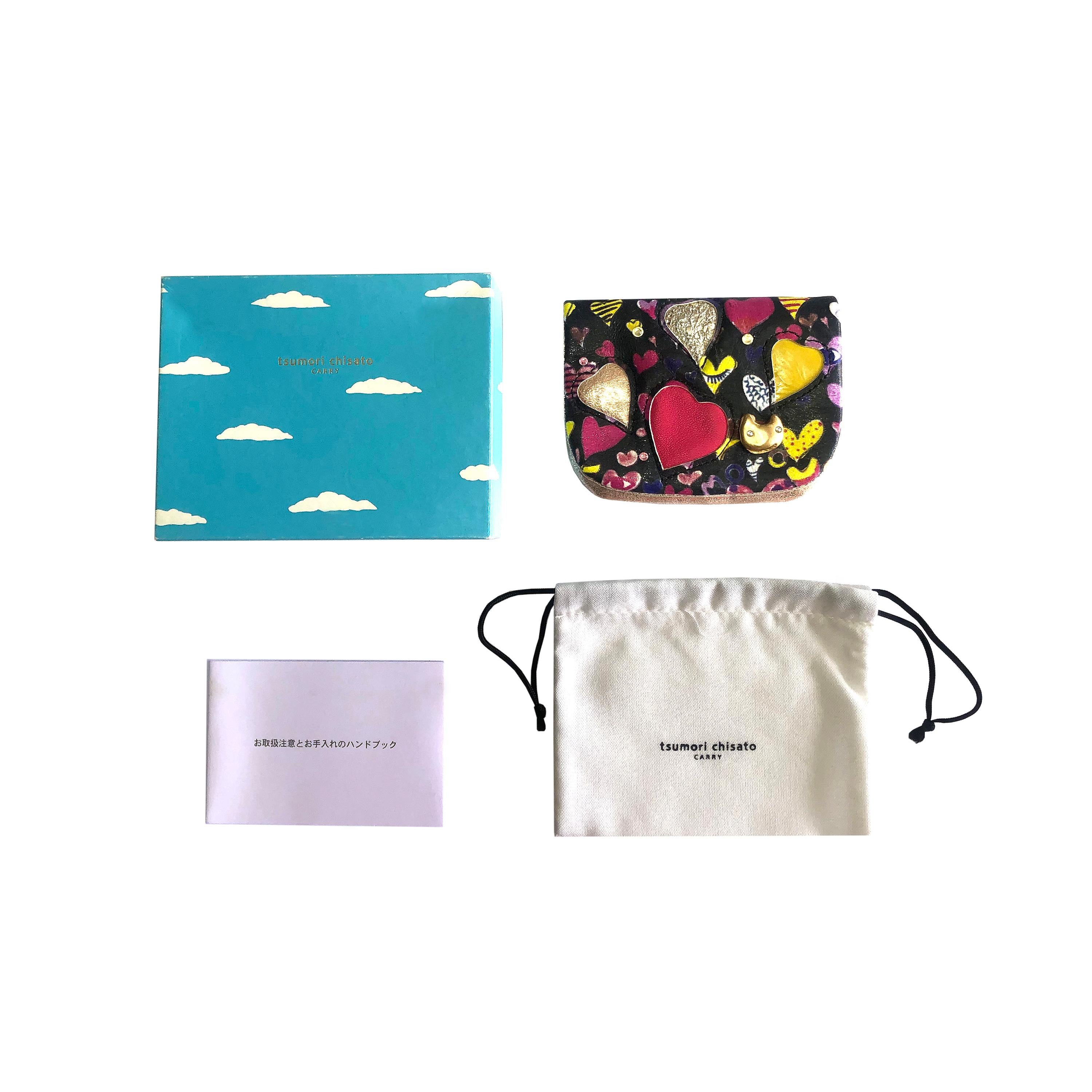Product Details: Tsumori Chisato - Leather Key Wallet / Purse
- Printed Leather, Rhinestone, Gold Metal & Leather Heart Detailing 
- Gold Cracked Leather Inner Lining + 2 Inner Compartments inc Zipper Fasten 
- x 1 Outer Pocket for Credit Cards 
- 3